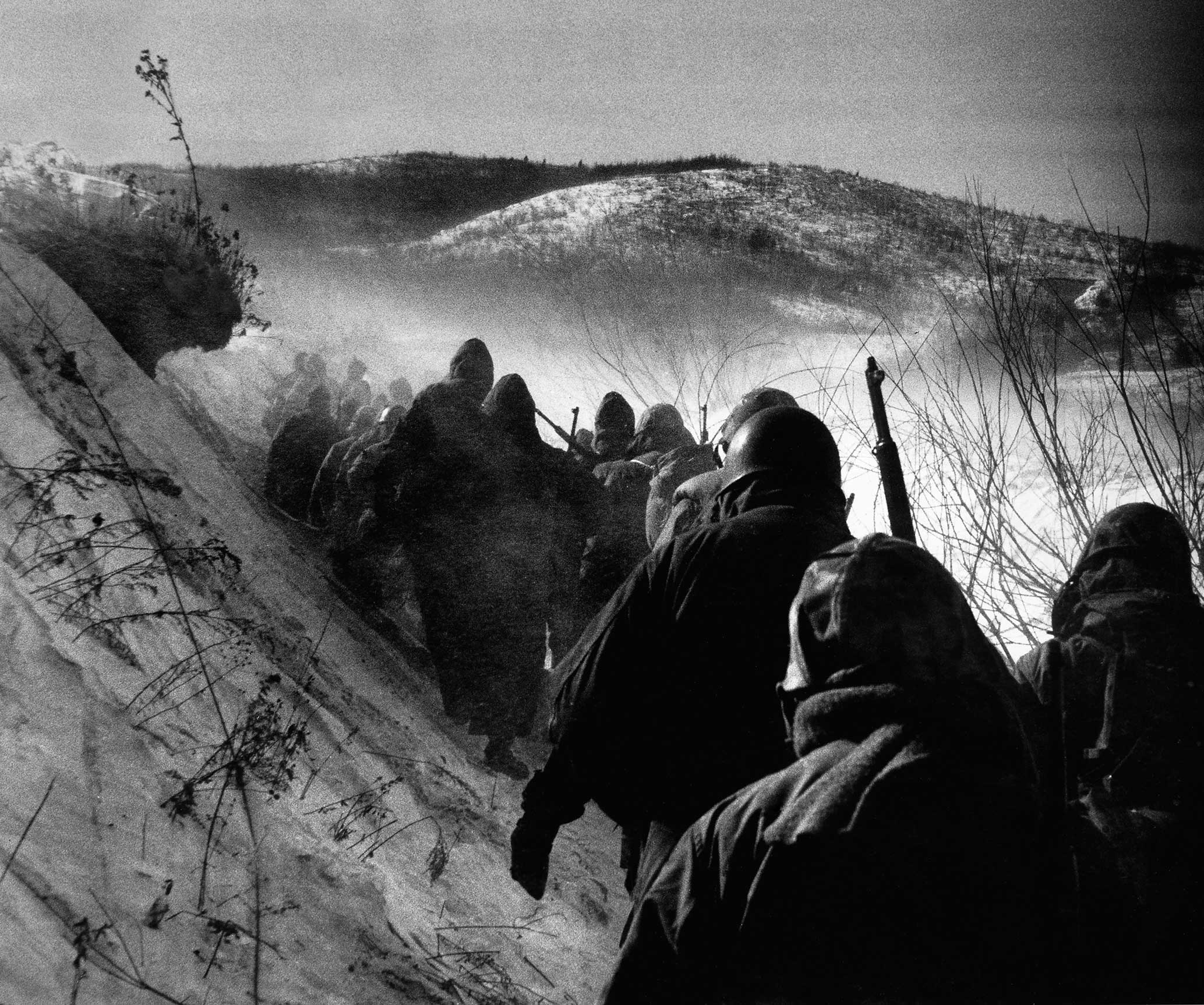 Early in the Korean War, American Marines march through bitter cold down a canyon road they dubbed "Nightmare Alley" during a grim retreat from the Chosin Reservoir. Originally published in the December 25, 1950, issue of LIFE.