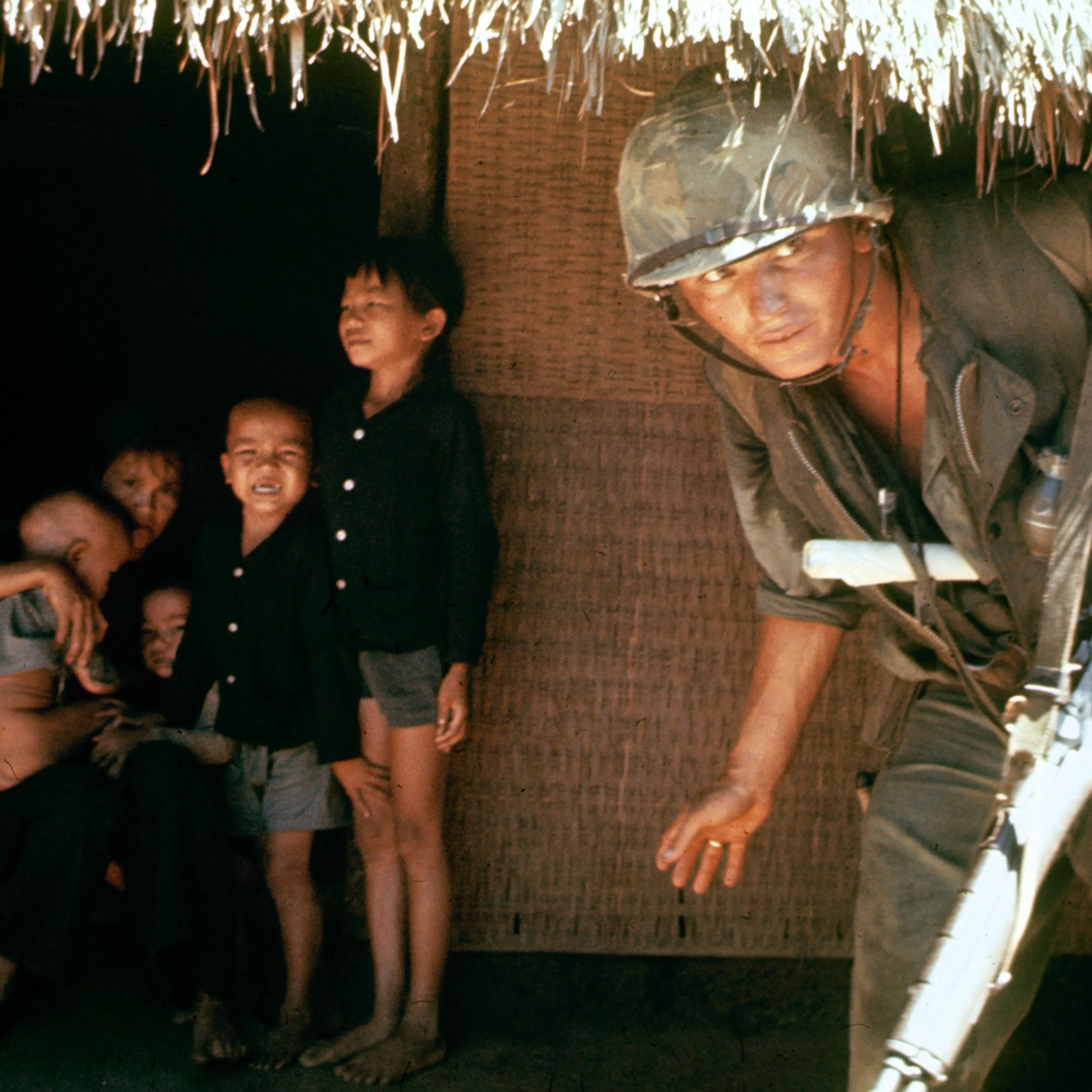 Within the village children shrink from a scout hunting the V.C. who strike from tunnels under huts.