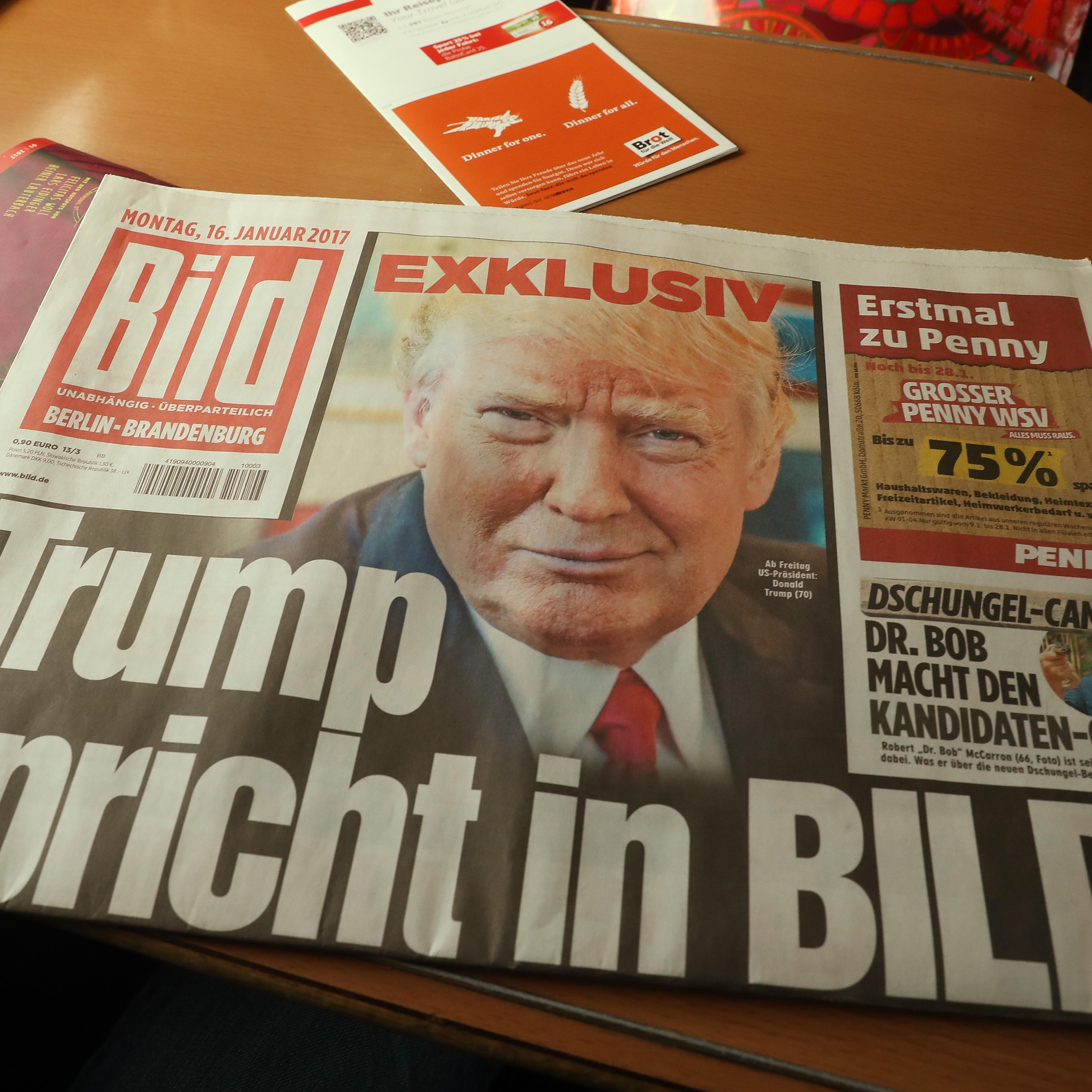 In this photo illustration a copy of the January 16 issue of German tabloid Bild Zeitung that features an exclusive interview with U.S. President-elect Donald Trump lies on a table in a train on January 16, 2017 in Berlin, Germany.