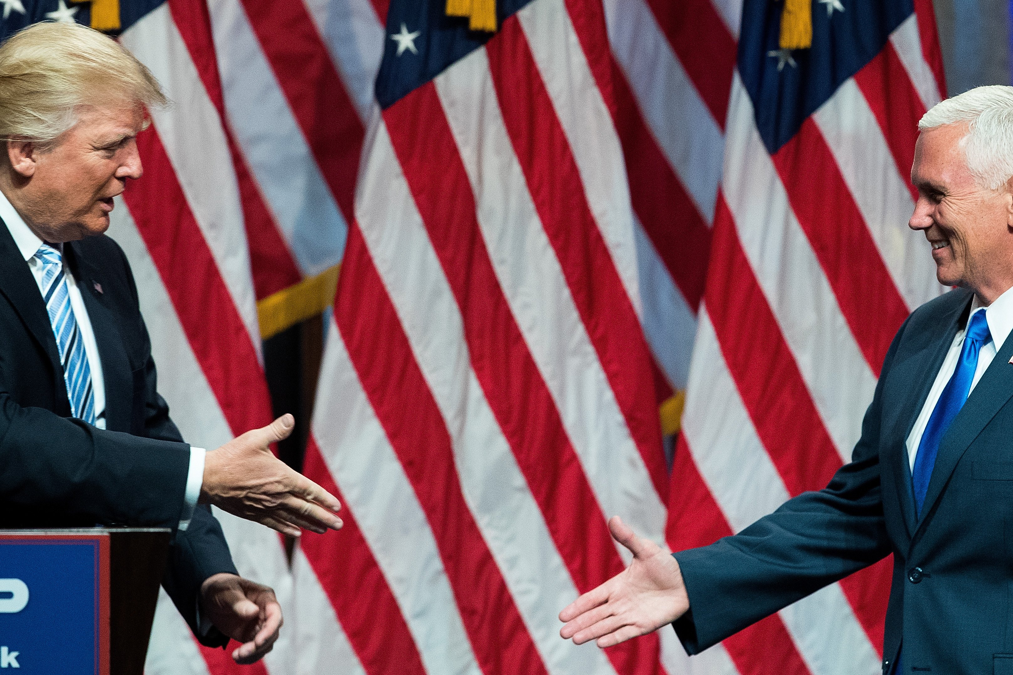 Republican presidential candidate Donald Trump prepares to shake hands with his newly selected vice presidential running mate Mike Pence, governor of Indiana, July 16, 2016 in New York City.