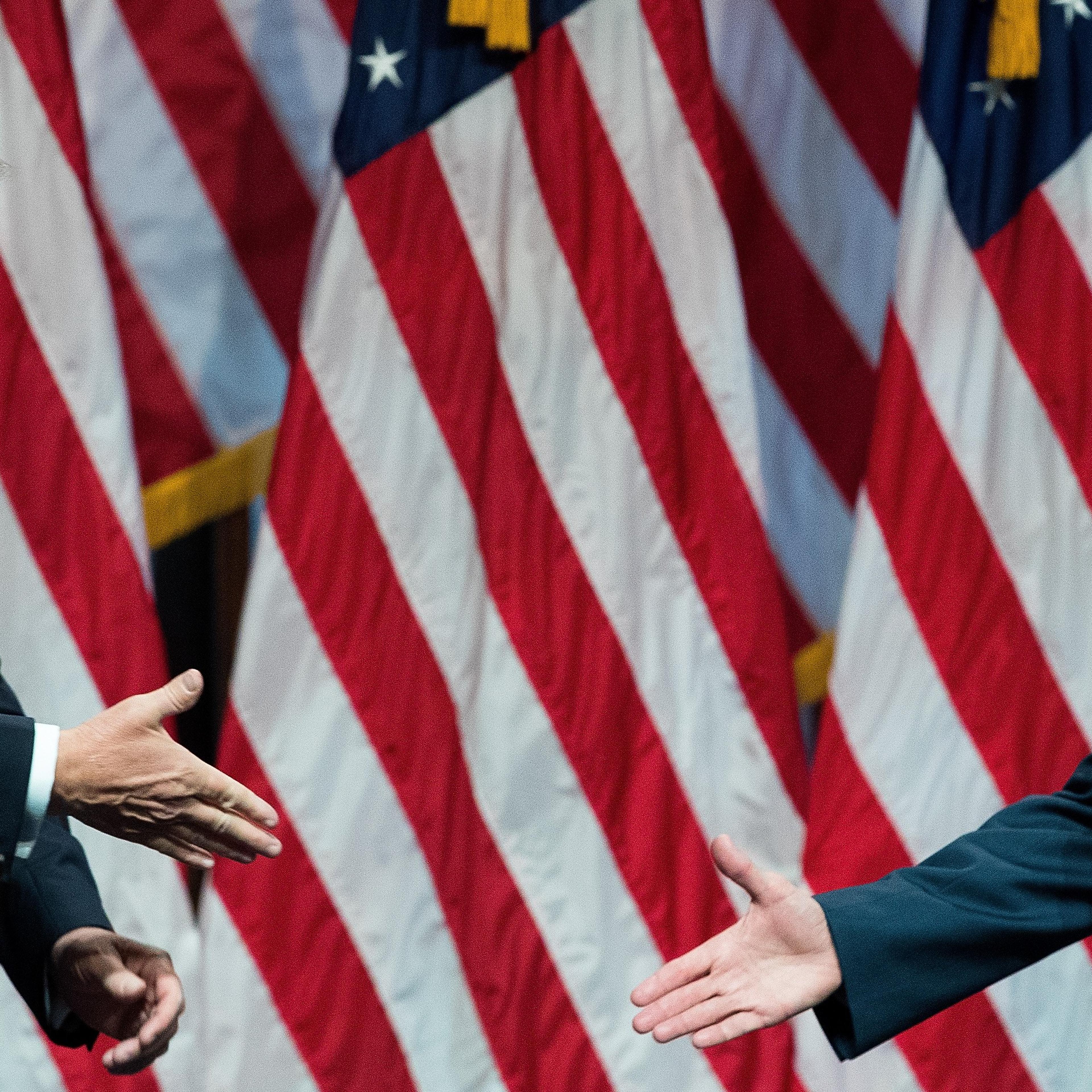 Republican presidential candidate Donald Trump prepares to shake hands with his newly selected vice presidential running mate Mike Pence, governor of Indiana, July 16, 2016 in New York City.