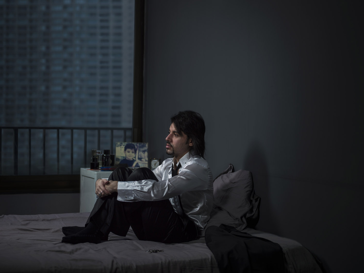 "I have tried to capture a moment of each of their stories within the frame of a window that looks out onto the cold concrete buildings which surround us daily."