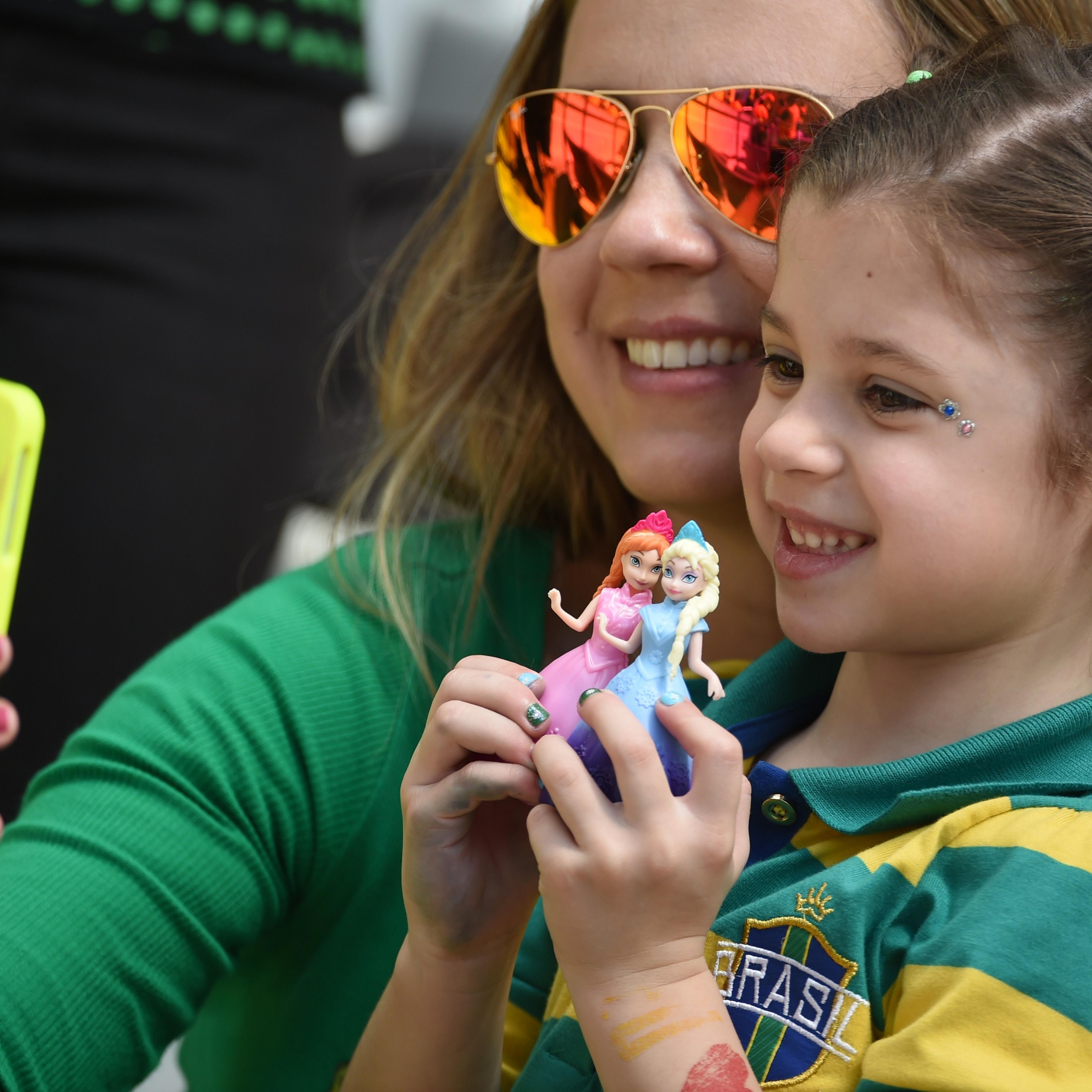 Australian fans take a picture with a smartphone before a Group B football match between Australia and Spain at the Baixada Arena in Curitiba during the 2014 FIFA World Cup on June 23, 2014.