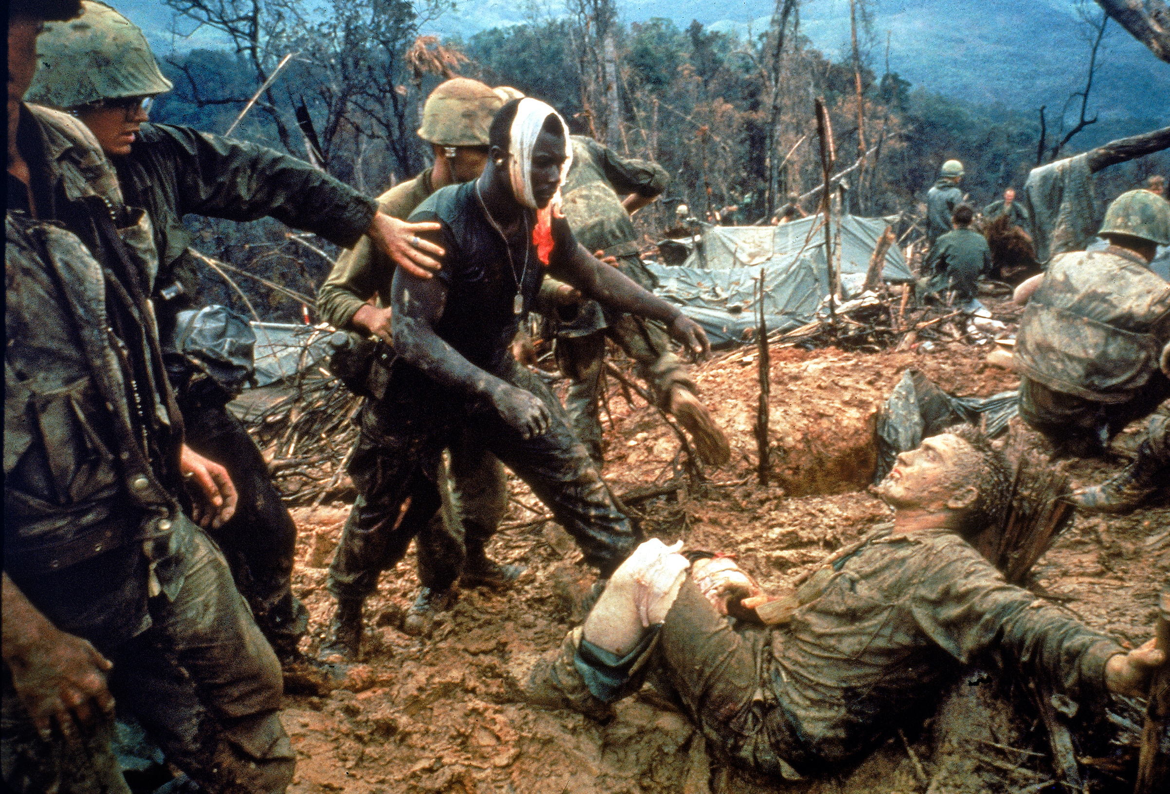 In October 1966, Marine Gunnery Sergeant Jeremiah Purdie approached a wounded comrade on Hill 484 near the DMZ, in what would become an iconic image of the war. Photographer Larry Burrows was killed in 1971