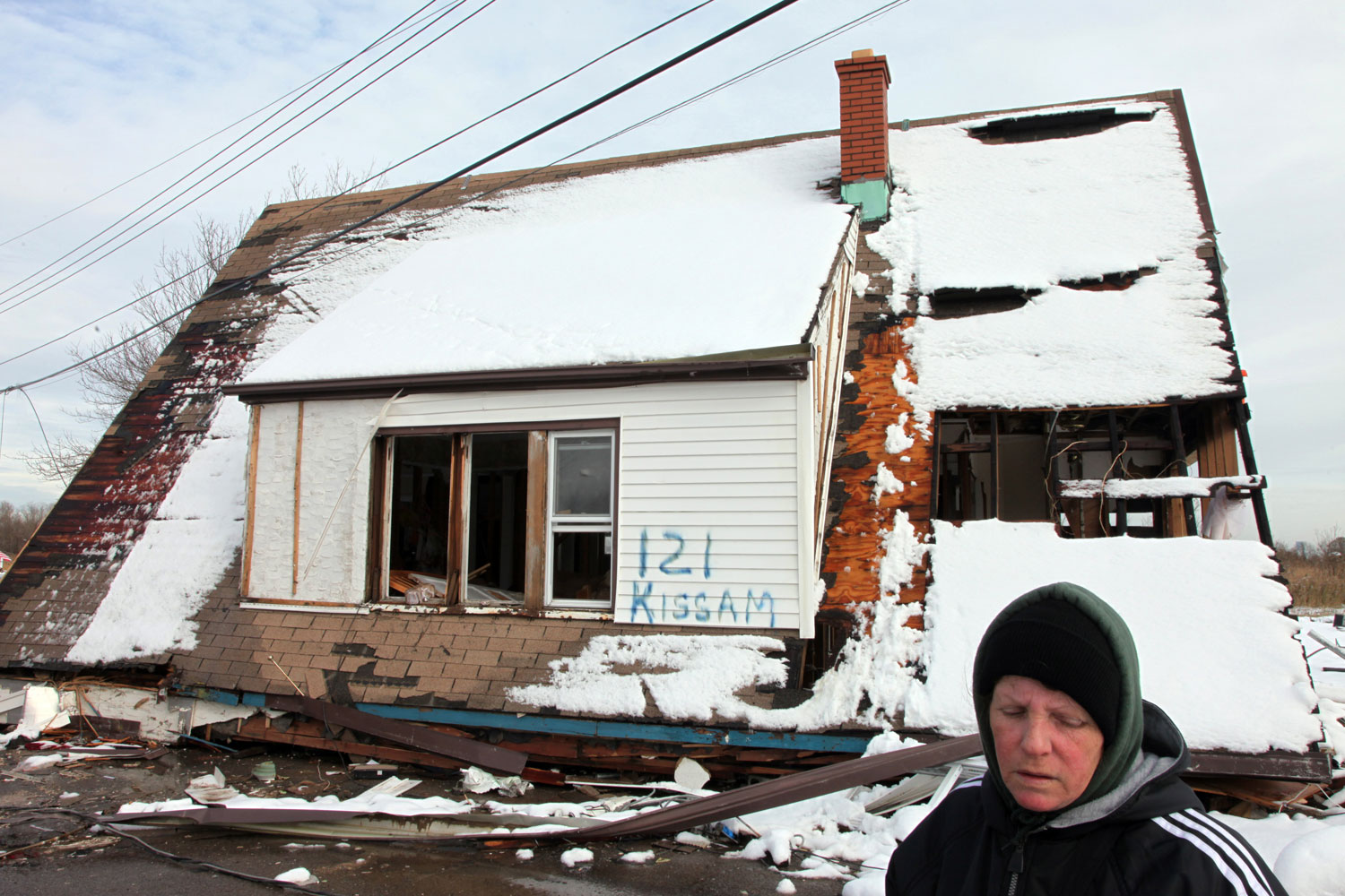 Image: Jane Caravello, who lost her home on Kissam Avenue, spray-painted street numbers onto the remains of her house and her neighbors' homes, to aid insurance adjustors with property damage assessment. Thirteen houses were ripped from their foundations