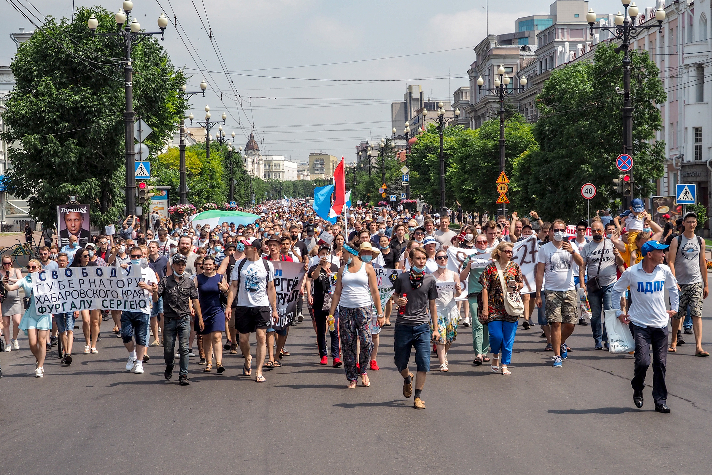 People hold posters that read: "Freedom for Khabarovsk region's governor Sergei Furgal" during a protest in Khabarovsk, Russia on July 18