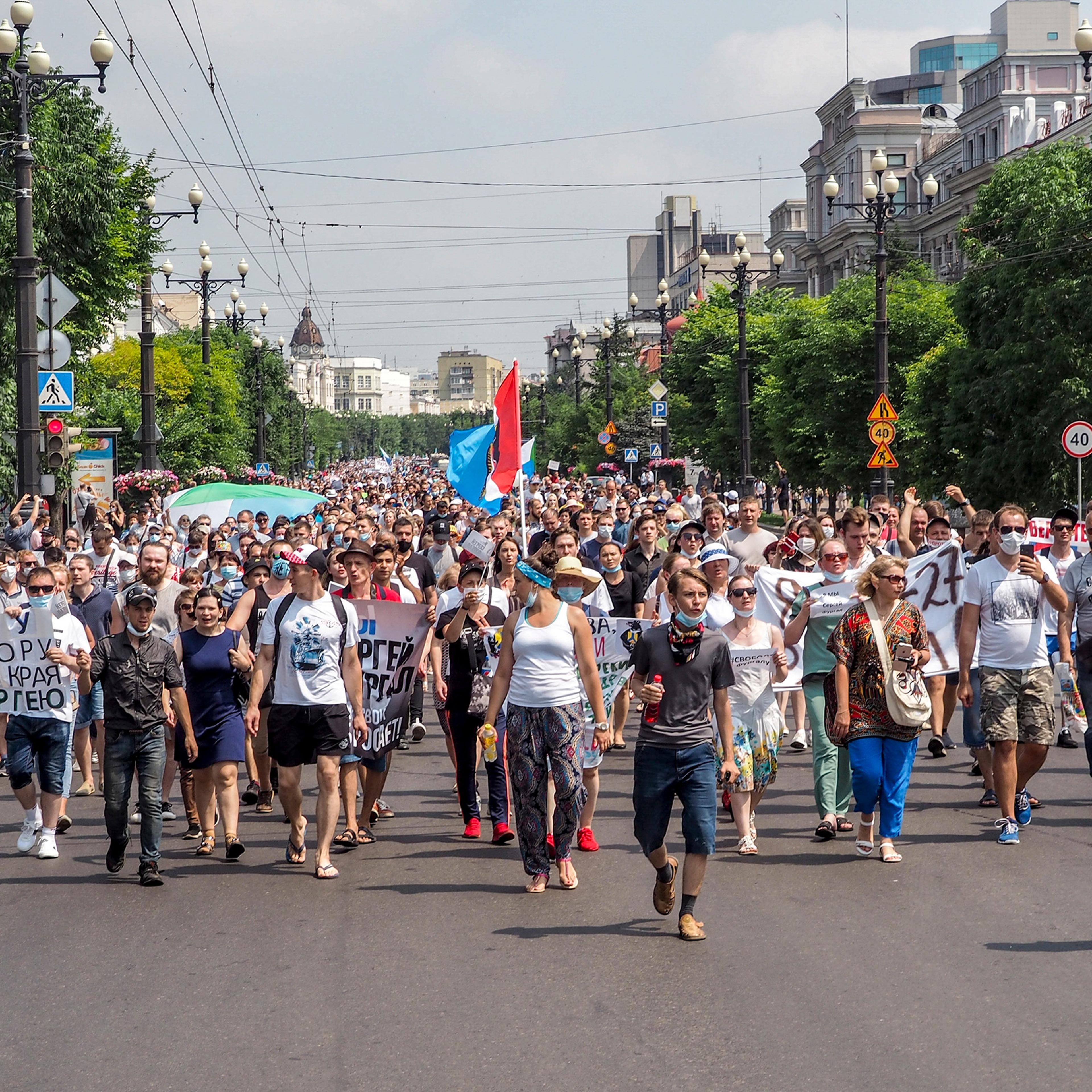 People hold posters that read: "Freedom for Khabarovsk region's governor Sergei Furgal" during a protest in Khabarovsk, Russia on July 18