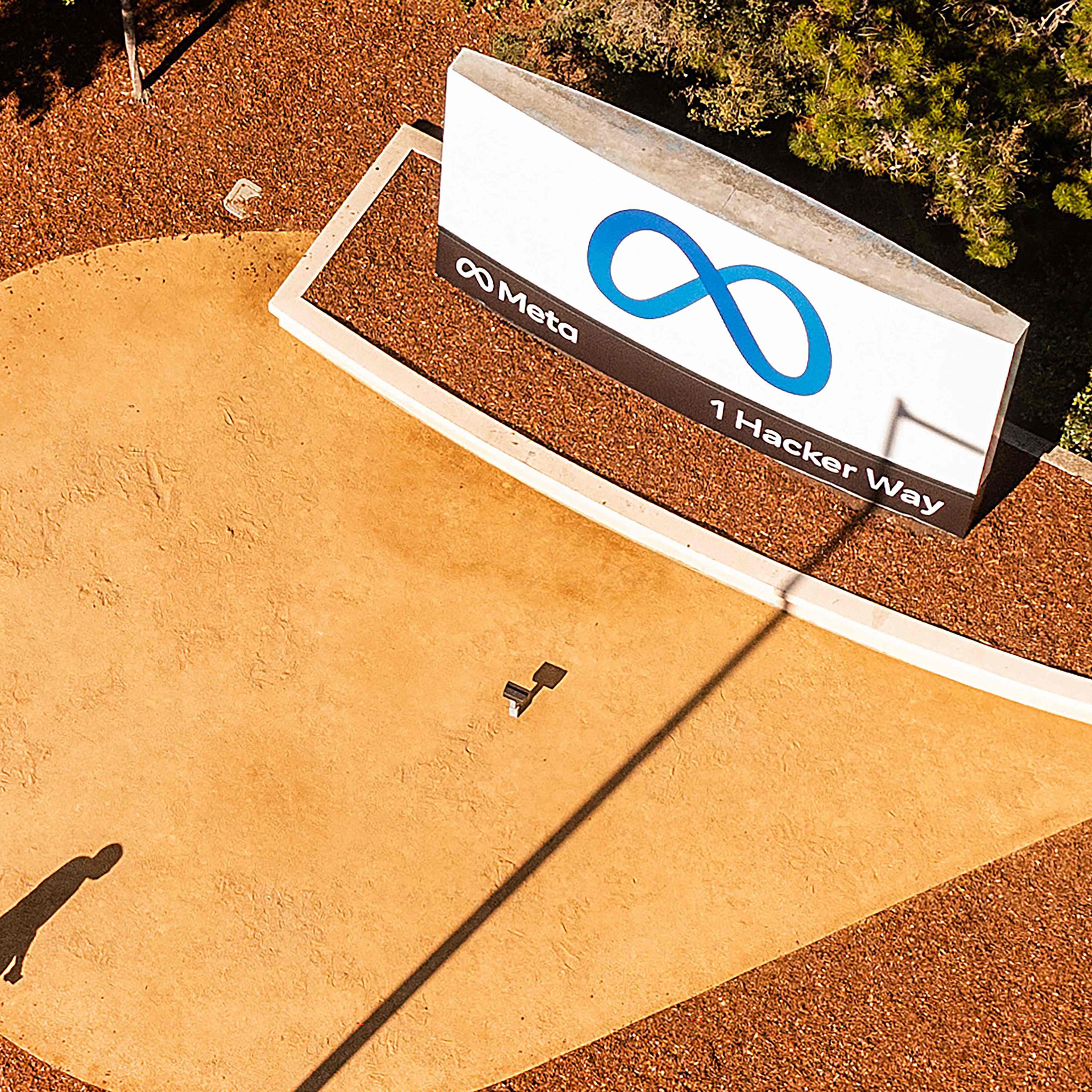 An aerial view shows a person passing a newly unveiled logo for Meta on Oct. 28, 2021 outside Meta headquarters in Menlo Park.