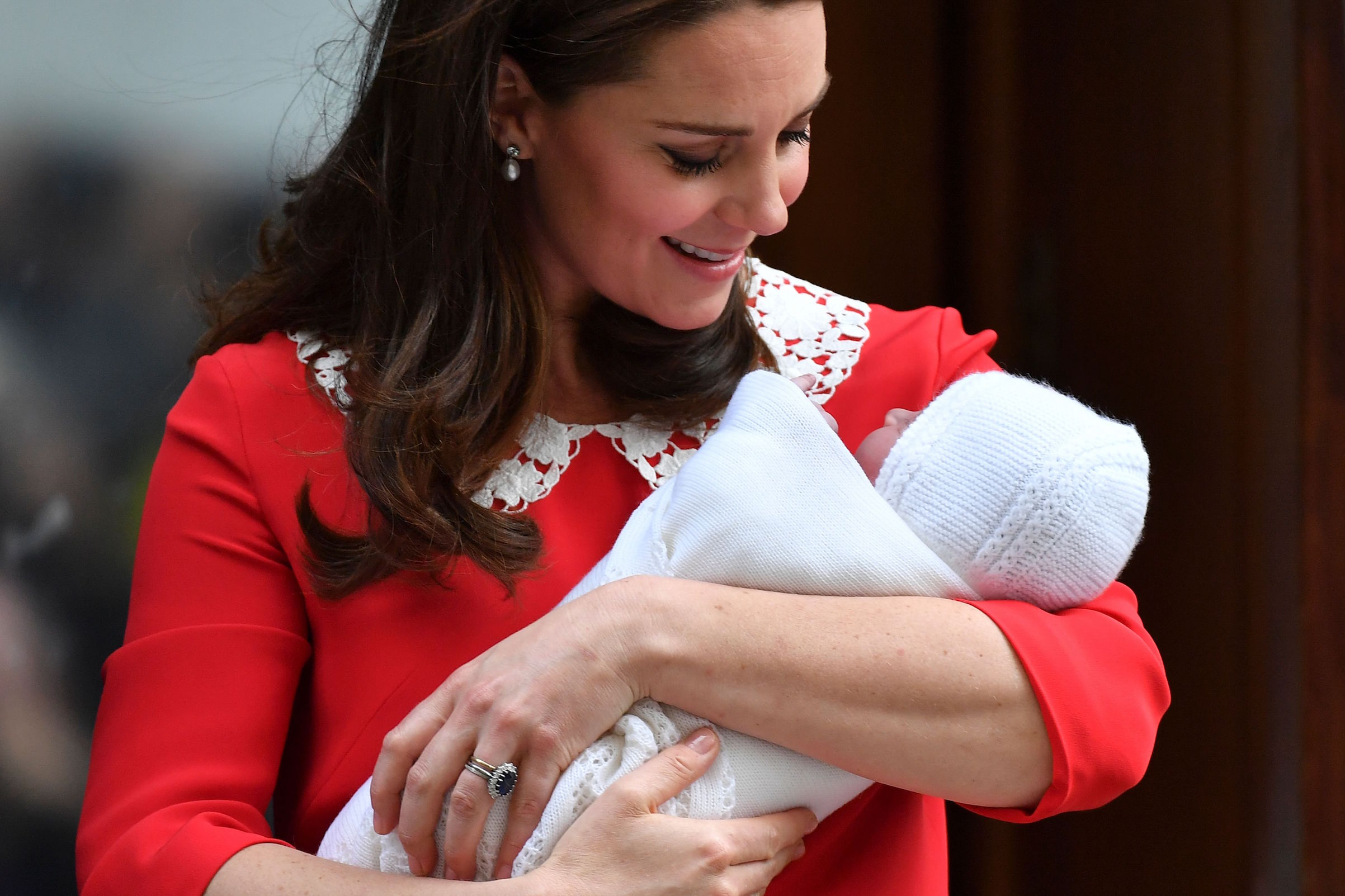 Kate Middleton looks at her newly-born son