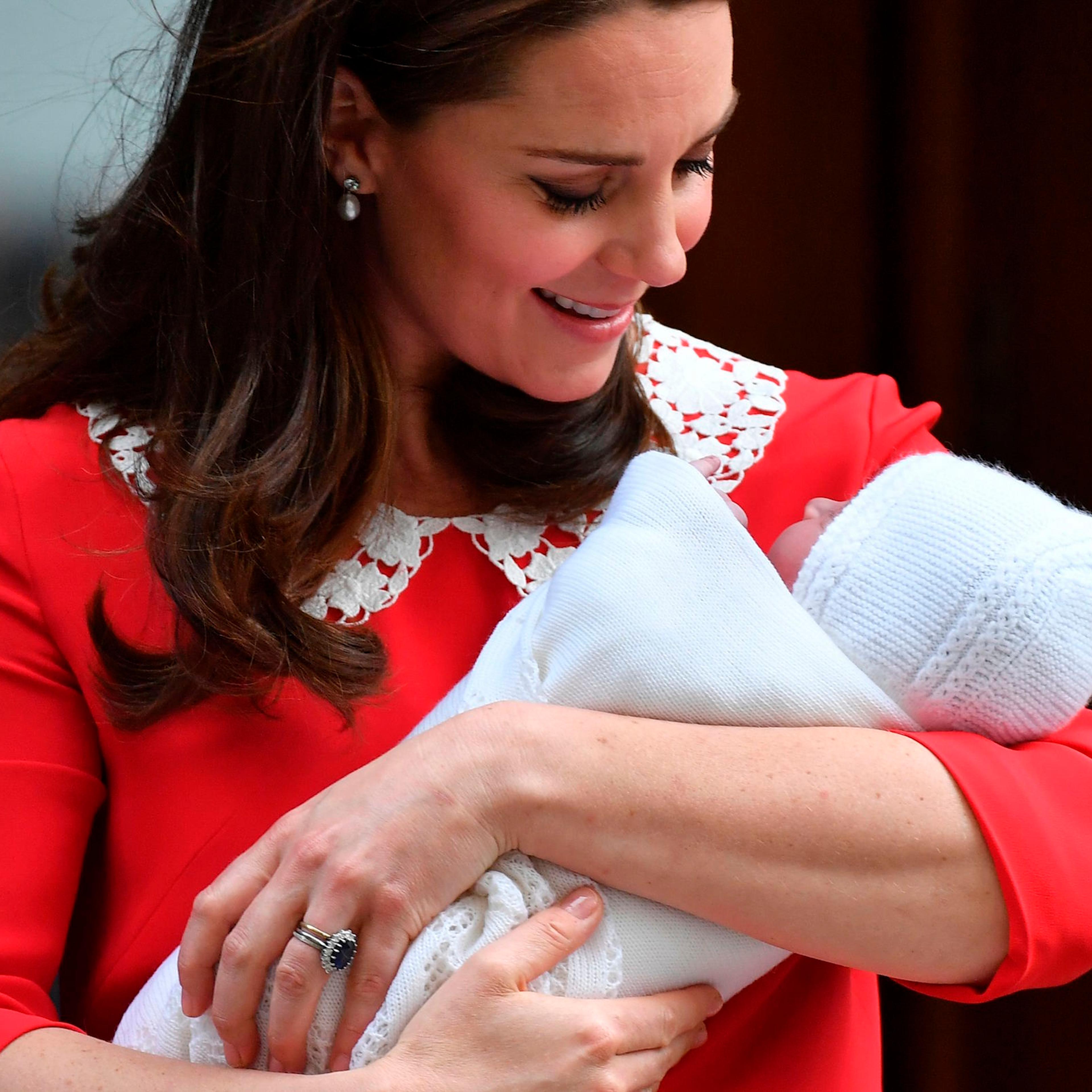 Kate Middleton looks at her newly-born son