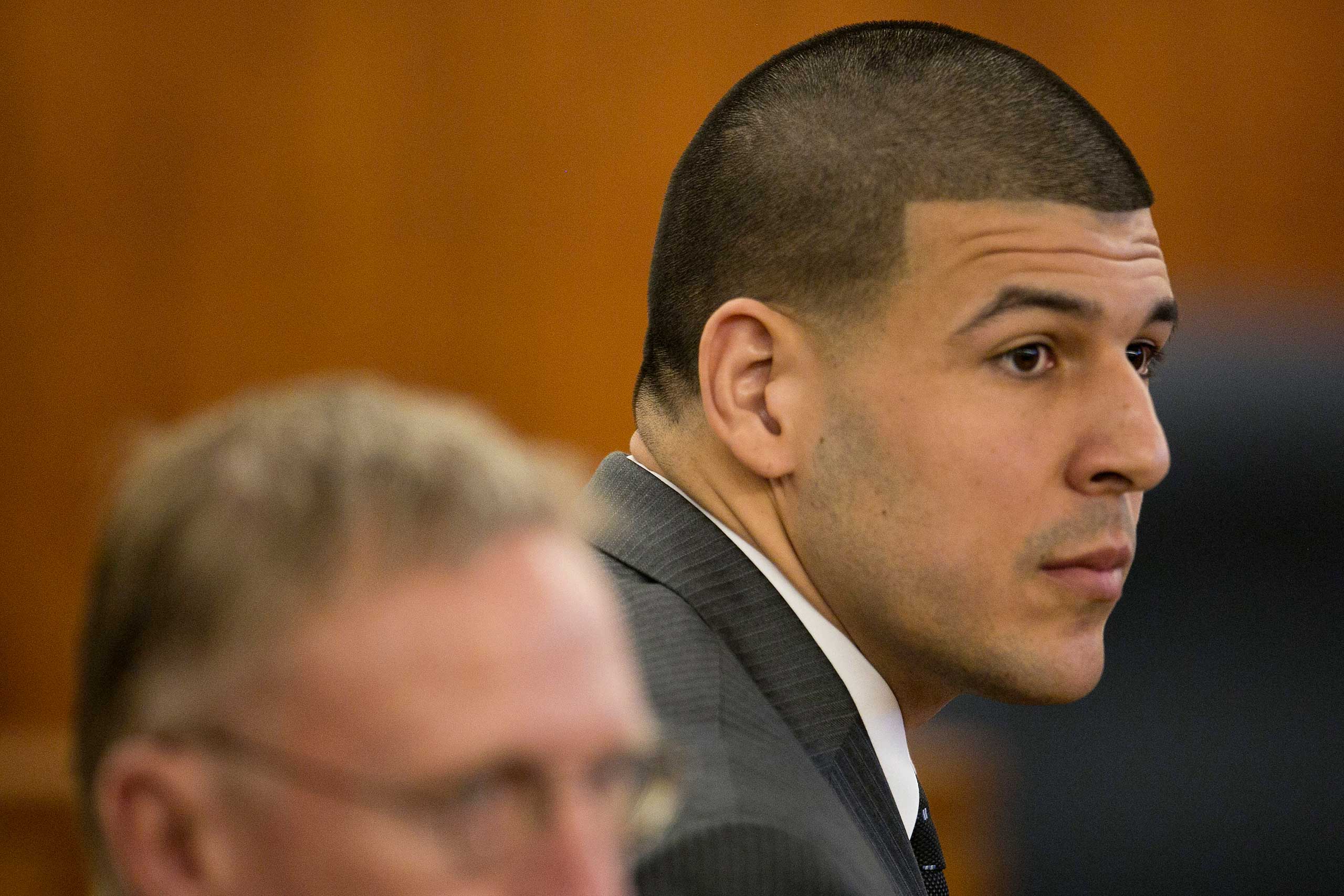 Former New England Patriots NFL football player Aaron Hernandez listens during his murder trial at the Bristol County Superior Court in Fall River, Mass., on Wednesday, April 15, 2015. Hernandez is accused of killing Odin Lloyd in June 2013. (Dominick Re
