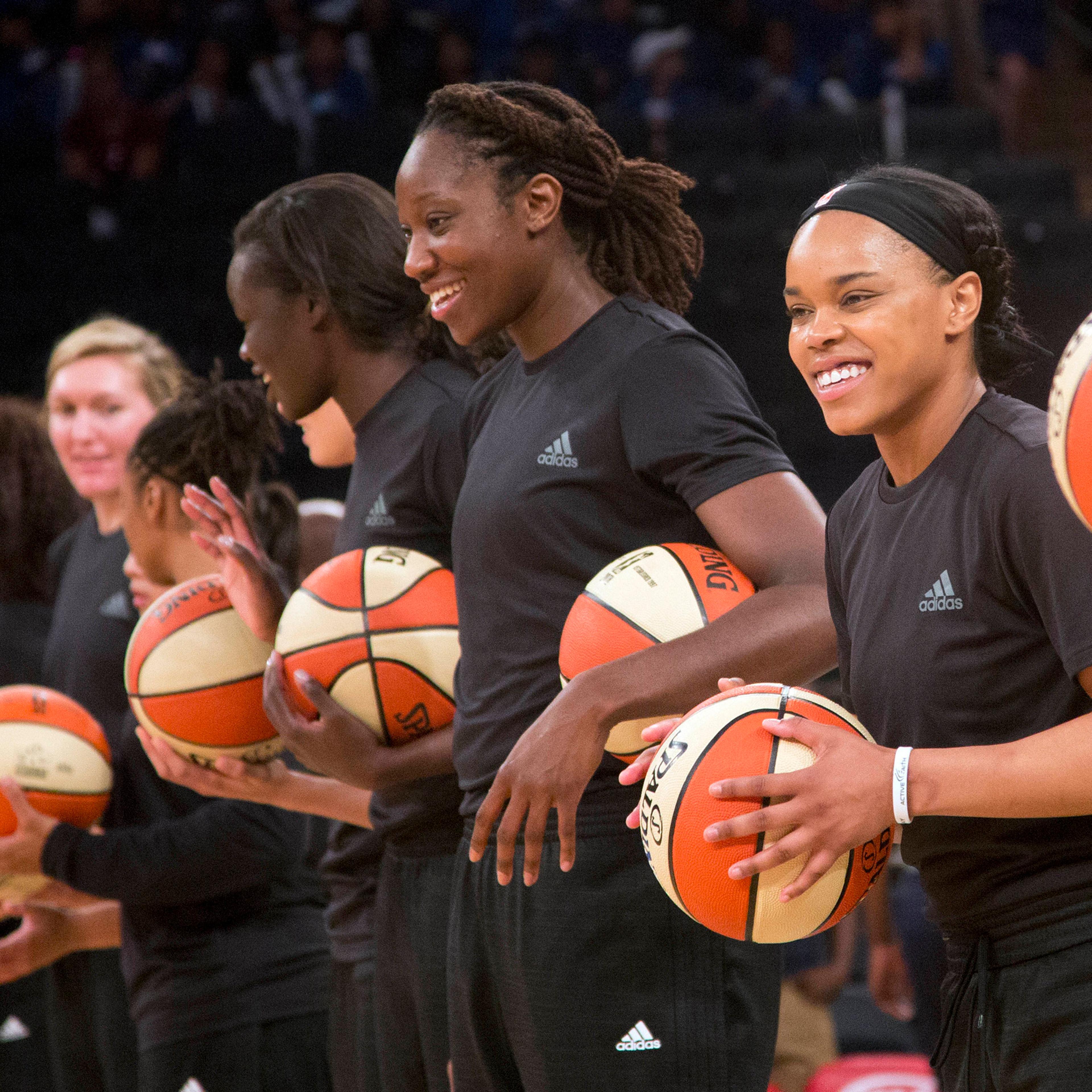 Members of the New York Liberty basketball team await the start of a game against the Atlanta Dream in New York City on July 13, 2016.