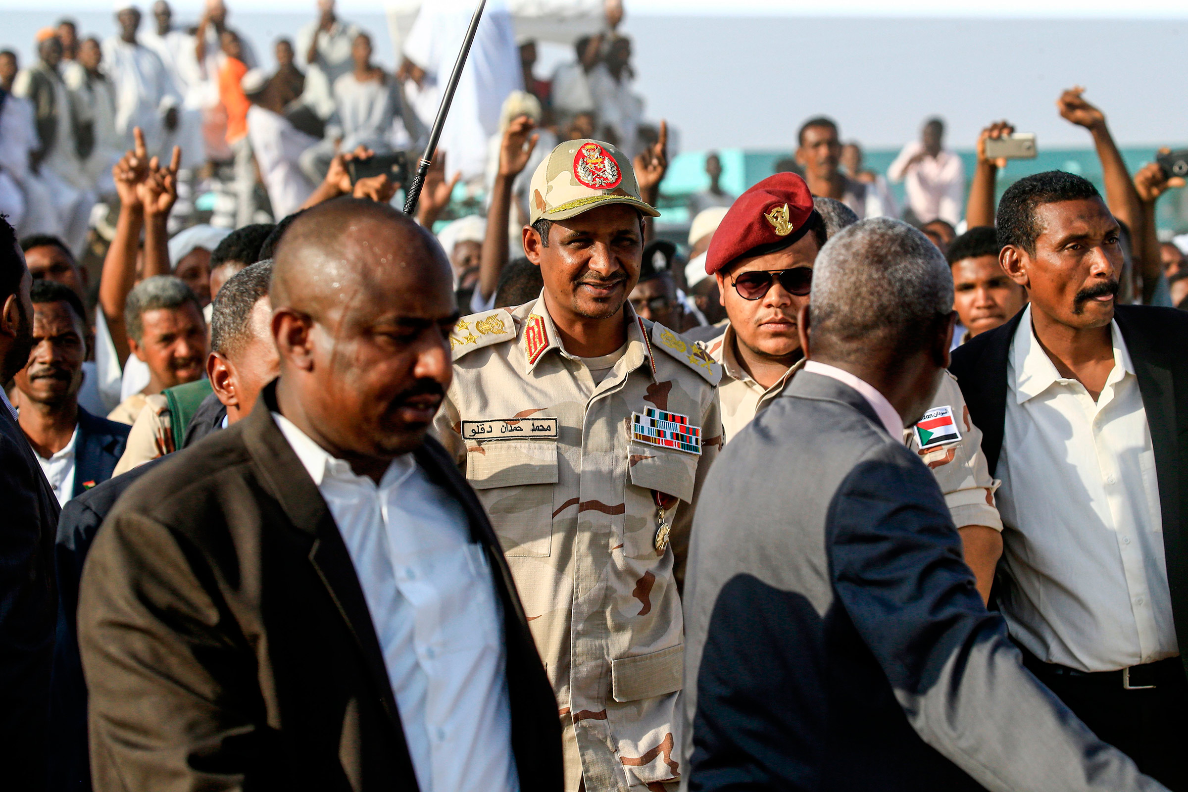 Mohamed Hamdan Dagalo, center, the deputy head of Sudan's ruling Transitional Military Council and commander of the Rapid Support Forces paramilitaries, walks in the village of Qarri, on June 15.