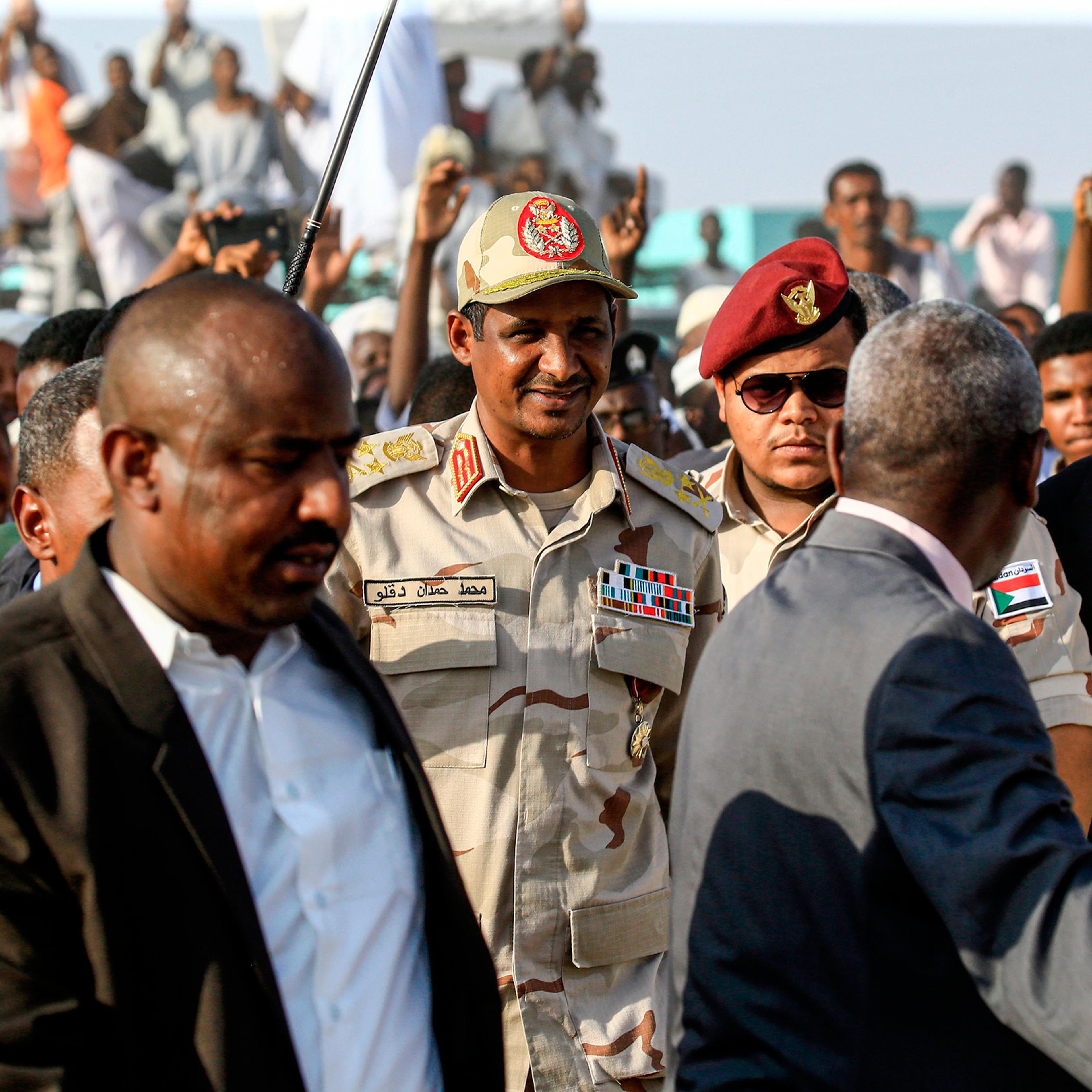Mohamed Hamdan Dagalo, center, the deputy head of Sudan's ruling Transitional Military Council and commander of the Rapid Support Forces paramilitaries, walks in the village of Qarri, on June 15.