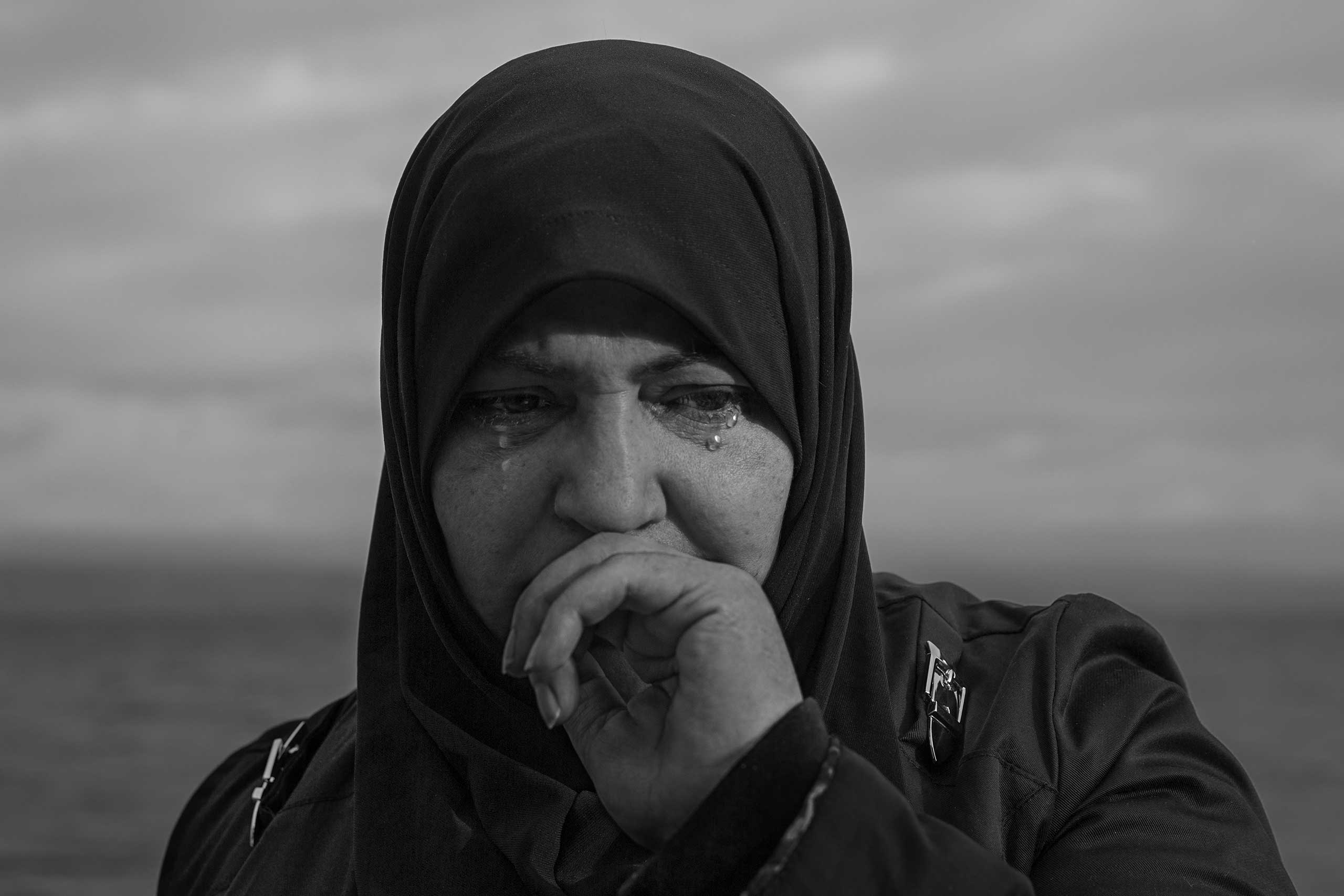 A woman cries after her boat arrives on the island of Lesbos, Greece.