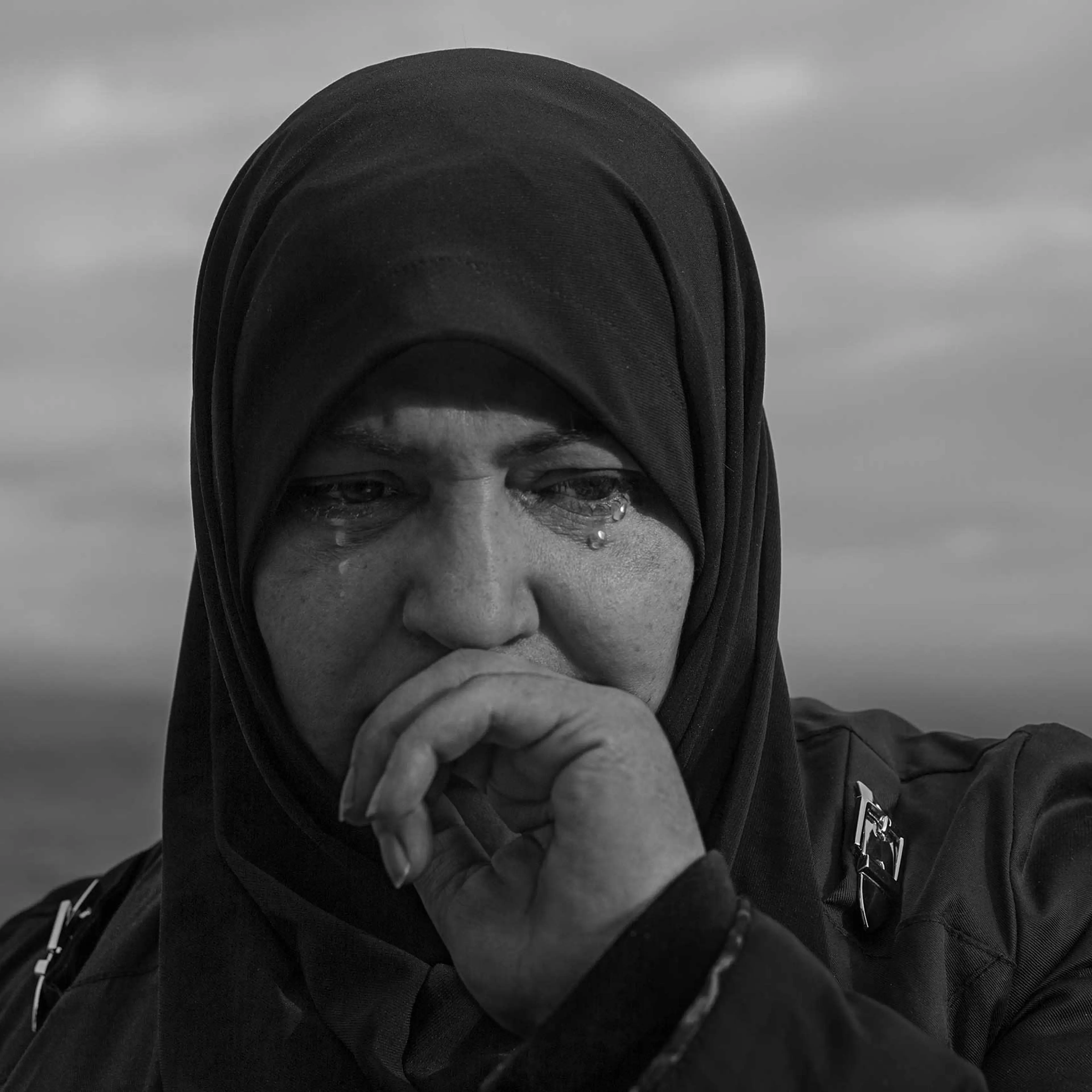 A woman cries after her boat arrives on the island of Lesbos, Greece.