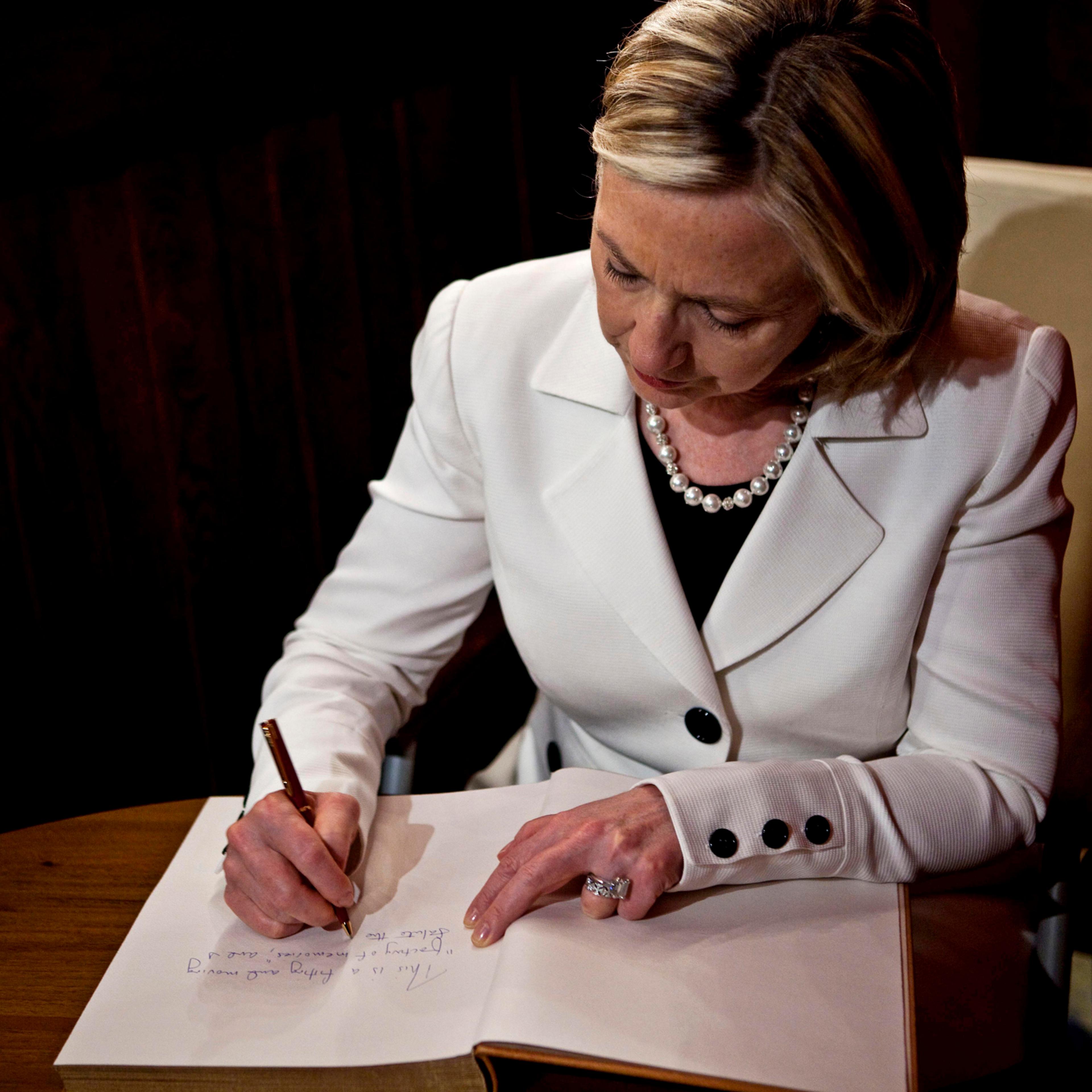 Secretary of State Hillary Rodham Clinton signs the guest book at the Schindler Factory Museum in Krakow, Poland on July 3, 2010.