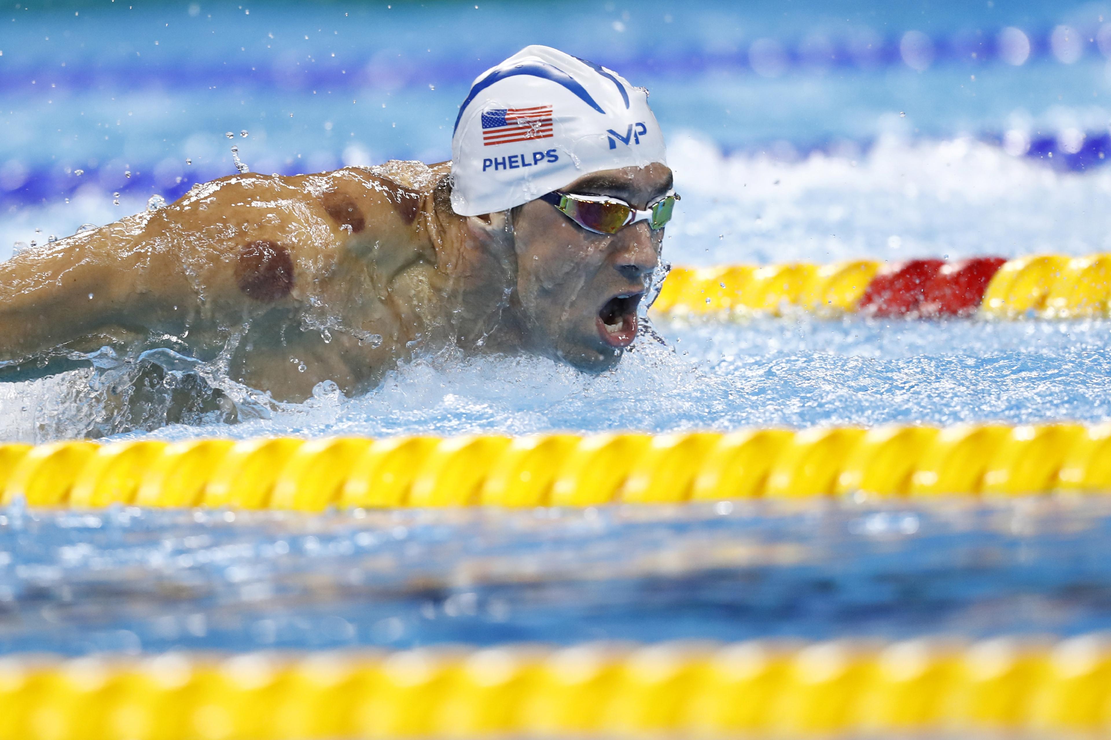USA's Michael Phelps competes in a Men's 200m Butterfly heat during the swimming event at the Rio 2016 Olympic Games at the Olympic Aquatics Stadium in Rio de Janeiro on August 8, 2016. / AFP / Odd Andersen (Photo credit should read ODD ANDERSEN/AFP/Gett