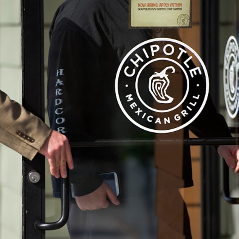 Pedestrians enter a Chipotle Mexican Grill in Martinez, California, U.S., on Monday, Feb. 2, 2015. Chipotle Mexican Grill is expected to release earnings figures on Feb 3. Photographer: David Paul Morris/Bloomberg