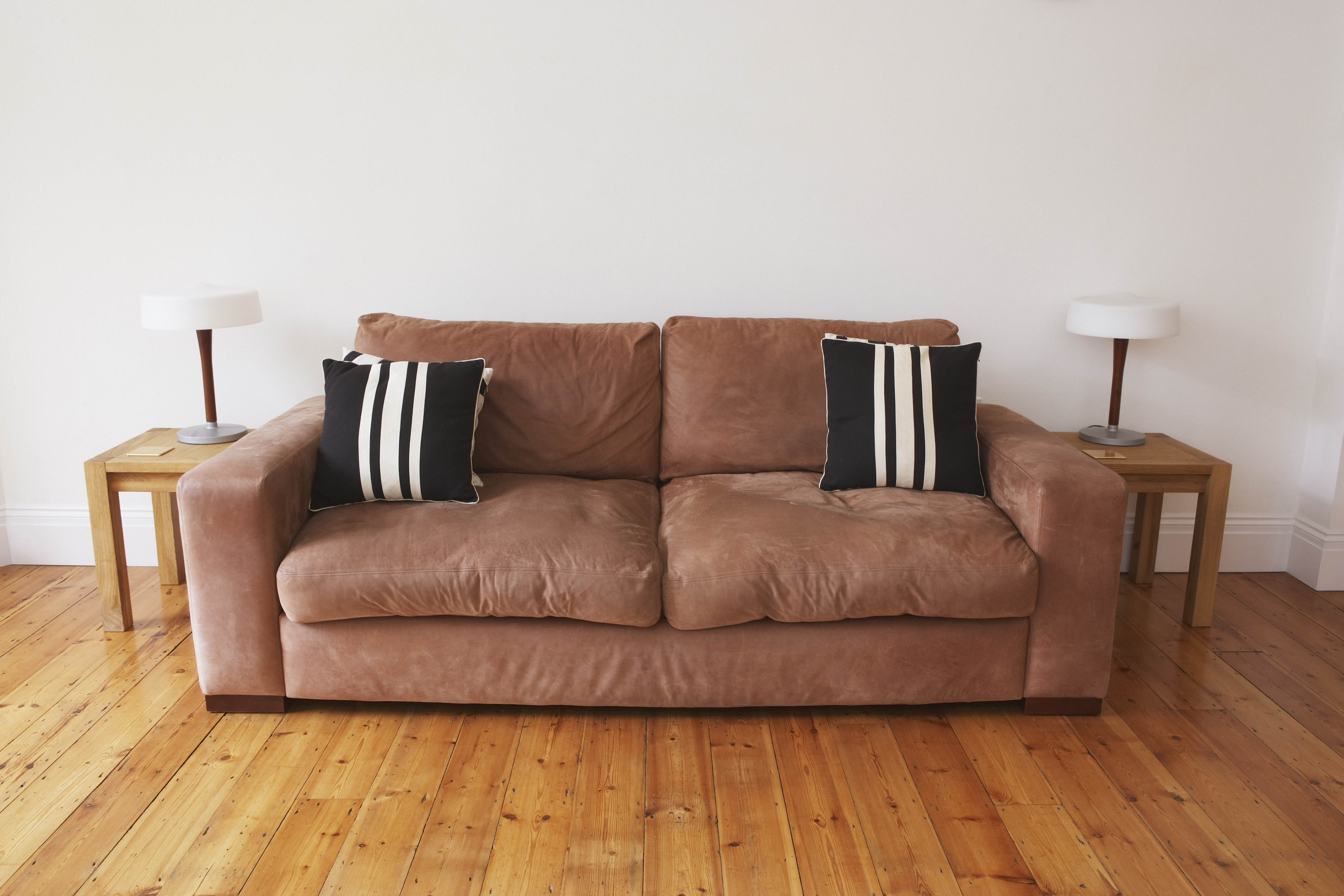 Empty living room with couch and end tables