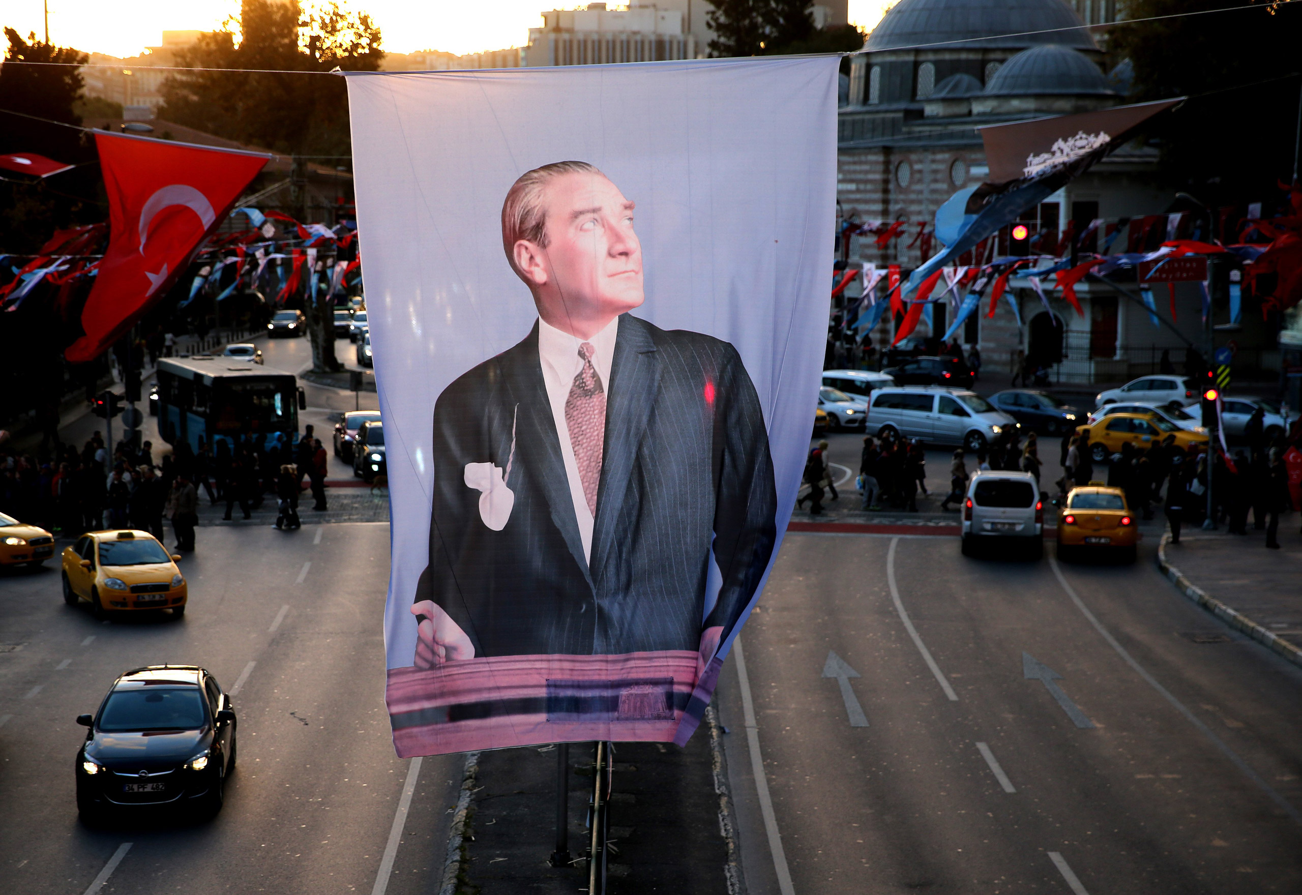 A portrait flag of the Turkish Republic founder Mustafa Kemal Ataturk hangs in Besiktas square, in Istanbul, Saturday, Oct. 31, 2015. Turkish political parties are making their closing appeals ahead of Sunday Nov. 1 crucial parliamentary vote. The electi