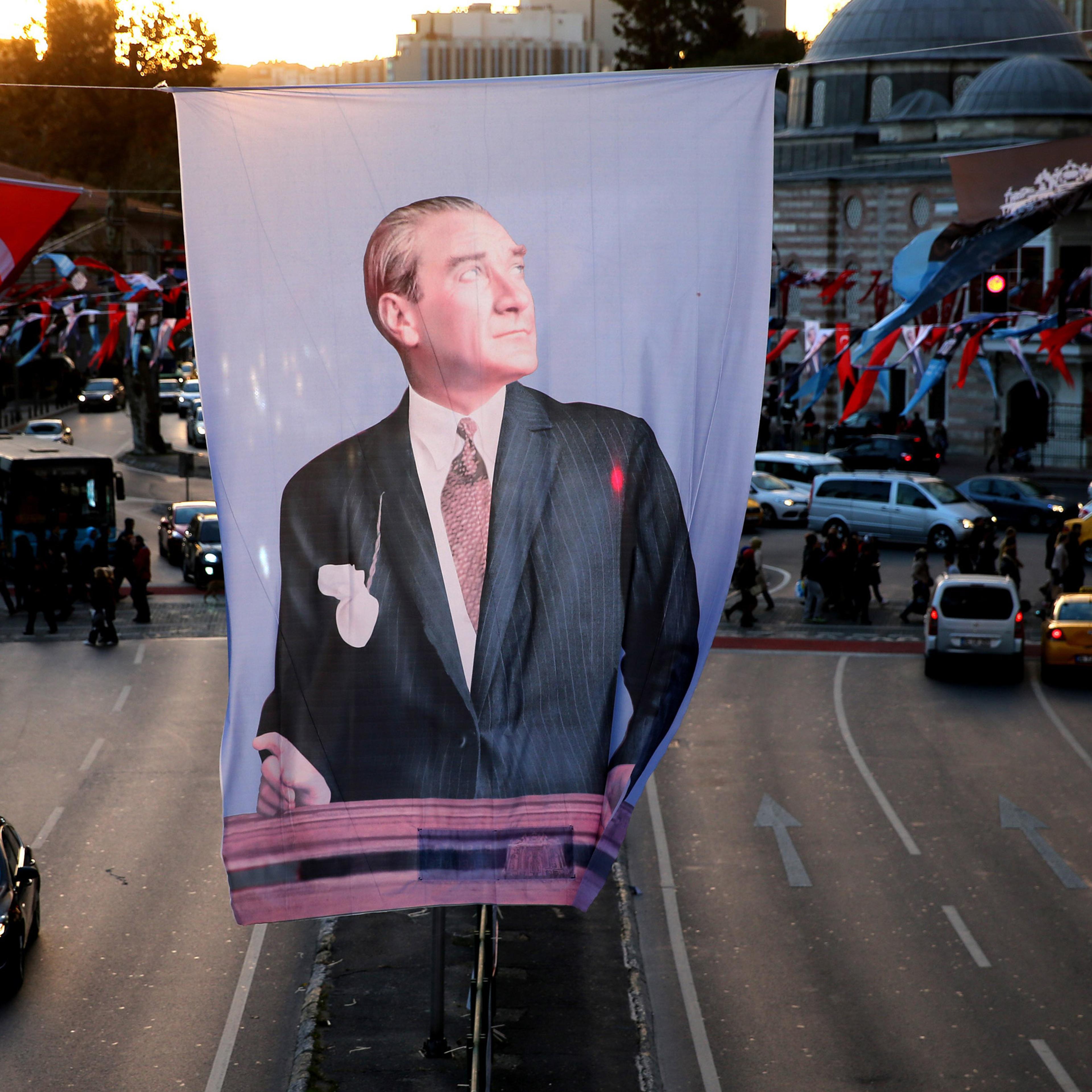 A portrait flag of the Turkish Republic founder Mustafa Kemal Ataturk hangs in Besiktas square, in Istanbul, Saturday, Oct. 31, 2015. Turkish political parties are making their closing appeals ahead of Sunday Nov. 1 crucial parliamentary vote. The electi