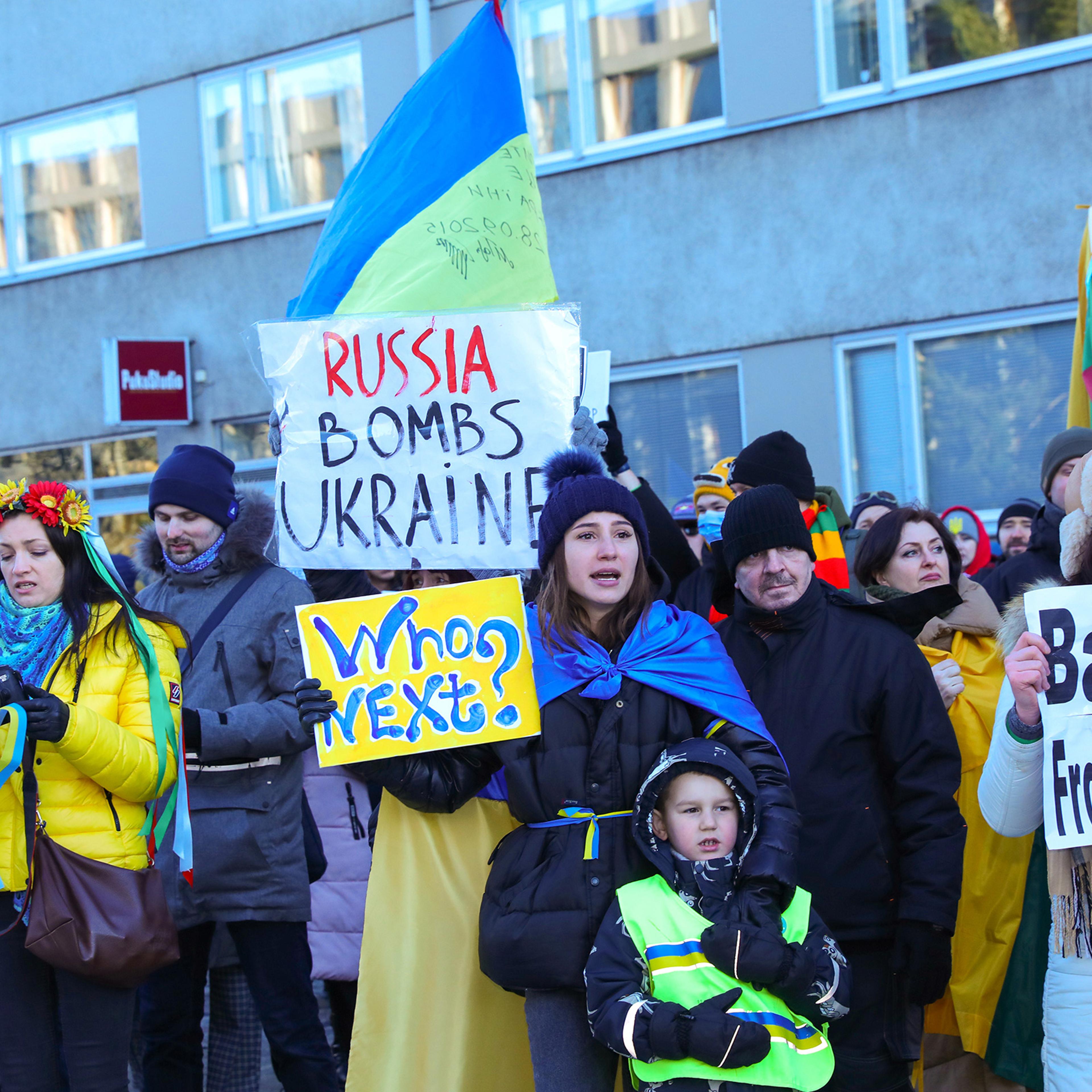 Protesters hold placards during an anti-war protest in front of the Embassy of Russia in Helsinki, Finland, Feb. 26, 2022.