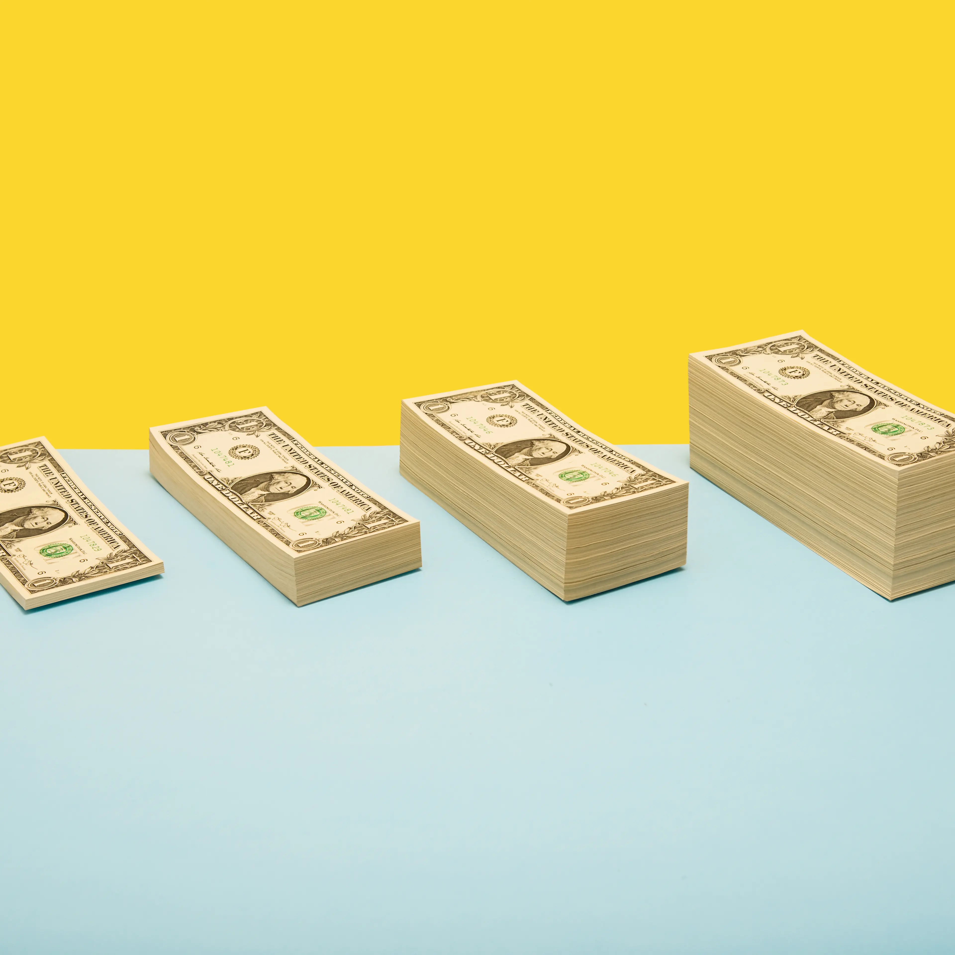 Stacks of US 1 dollar bills in ascending order