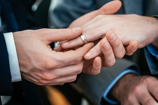 Gay Wedding Groom Placing Ring On Husband