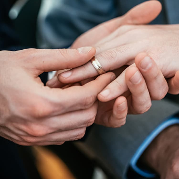 Gay Wedding Groom Placing Ring On Husband