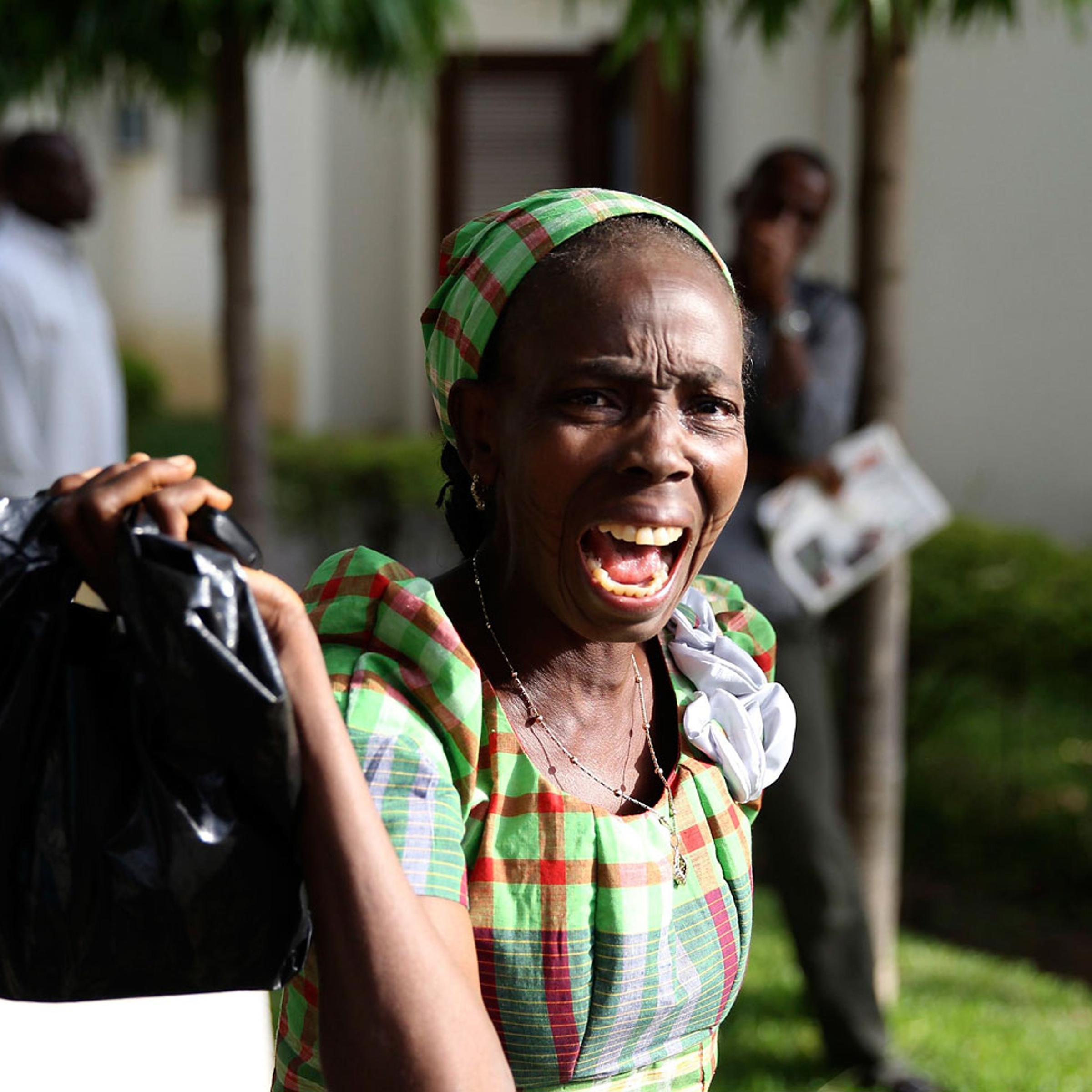 A bystander reacts as she sees victims of a bomb blast arriving at the Asokoro General Hospital in Abuja, April 14, 2014.