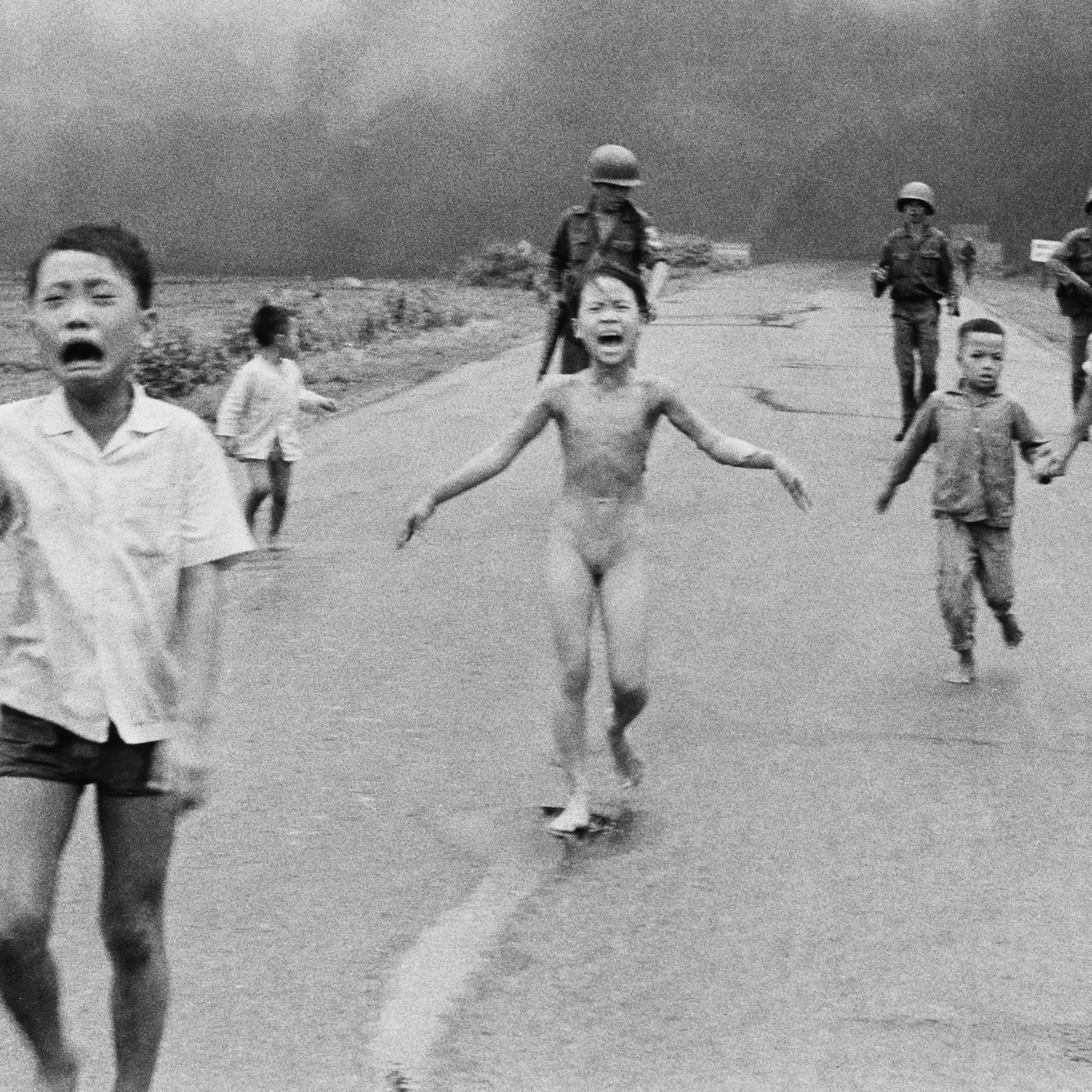 South Vietnamese forces follow after terrified children, including 9-year-old Kim Phuc, center, as they run down Route 1 near Trang Bang after an aerial napalm attack on suspected Vietcong hiding places on June 8, 1972.