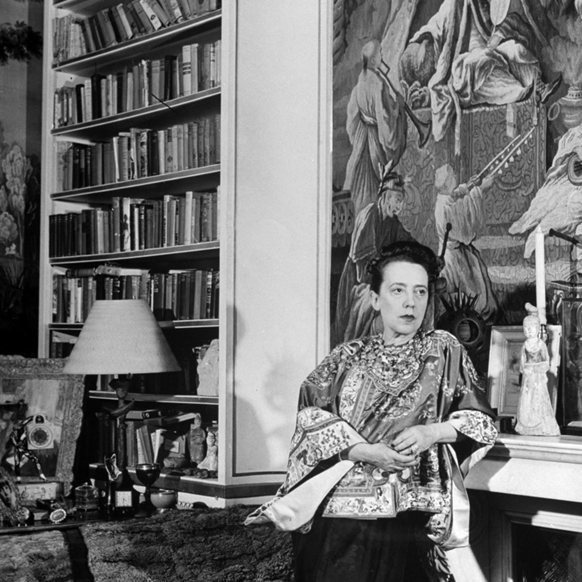 Fashion designer Elsa Schiaparelli in her study -- filled with treasures, paintings and books -- in Paris, 1947.