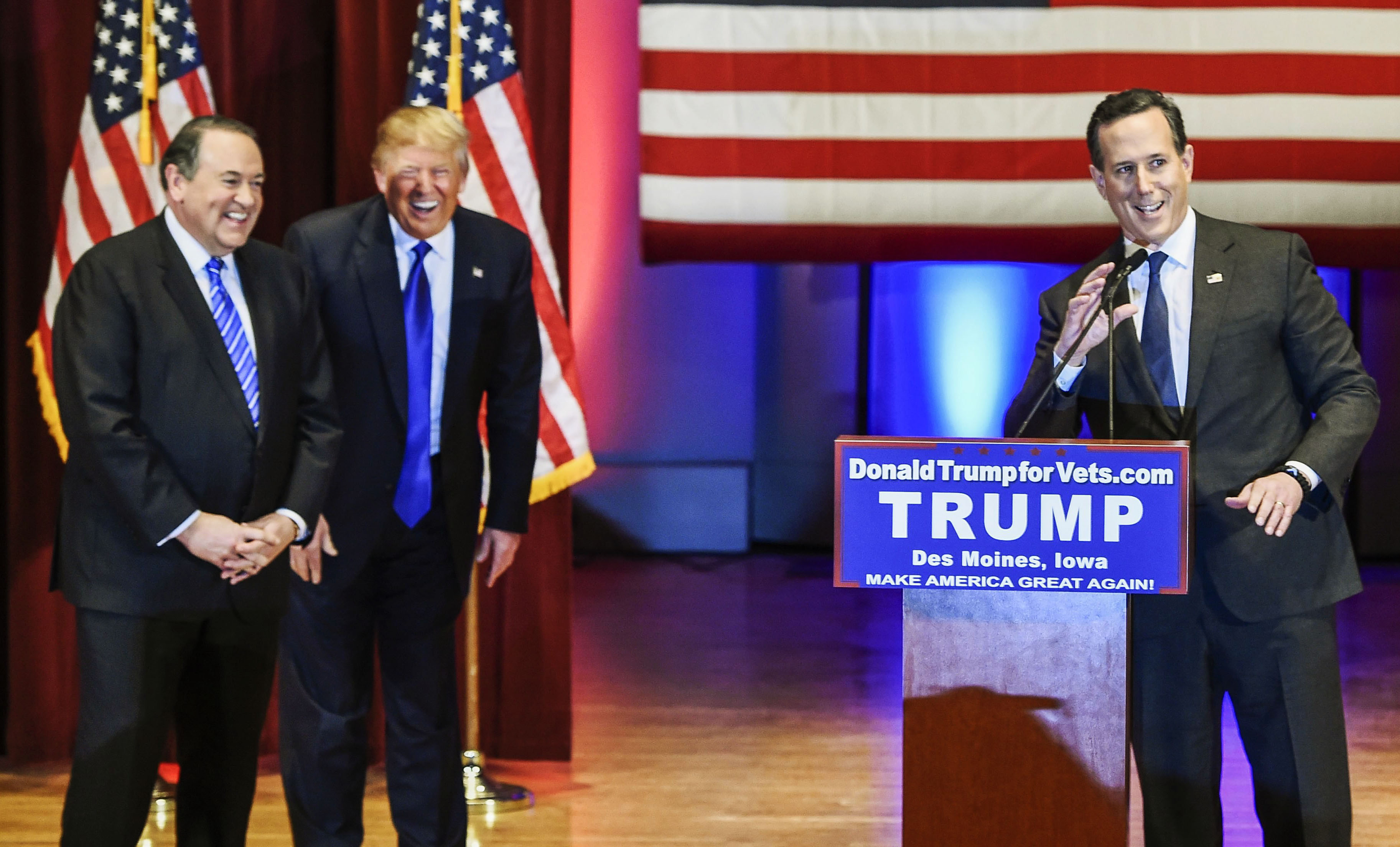 Republican presidential candidates, from left, Mike Huckabee, Donald Trump and Rick Santorum appear at a special event to benefit veterans organizations at Drake University instead of participating in a Fox News debate in Des Moines, Iowa, on Jan 28, 201