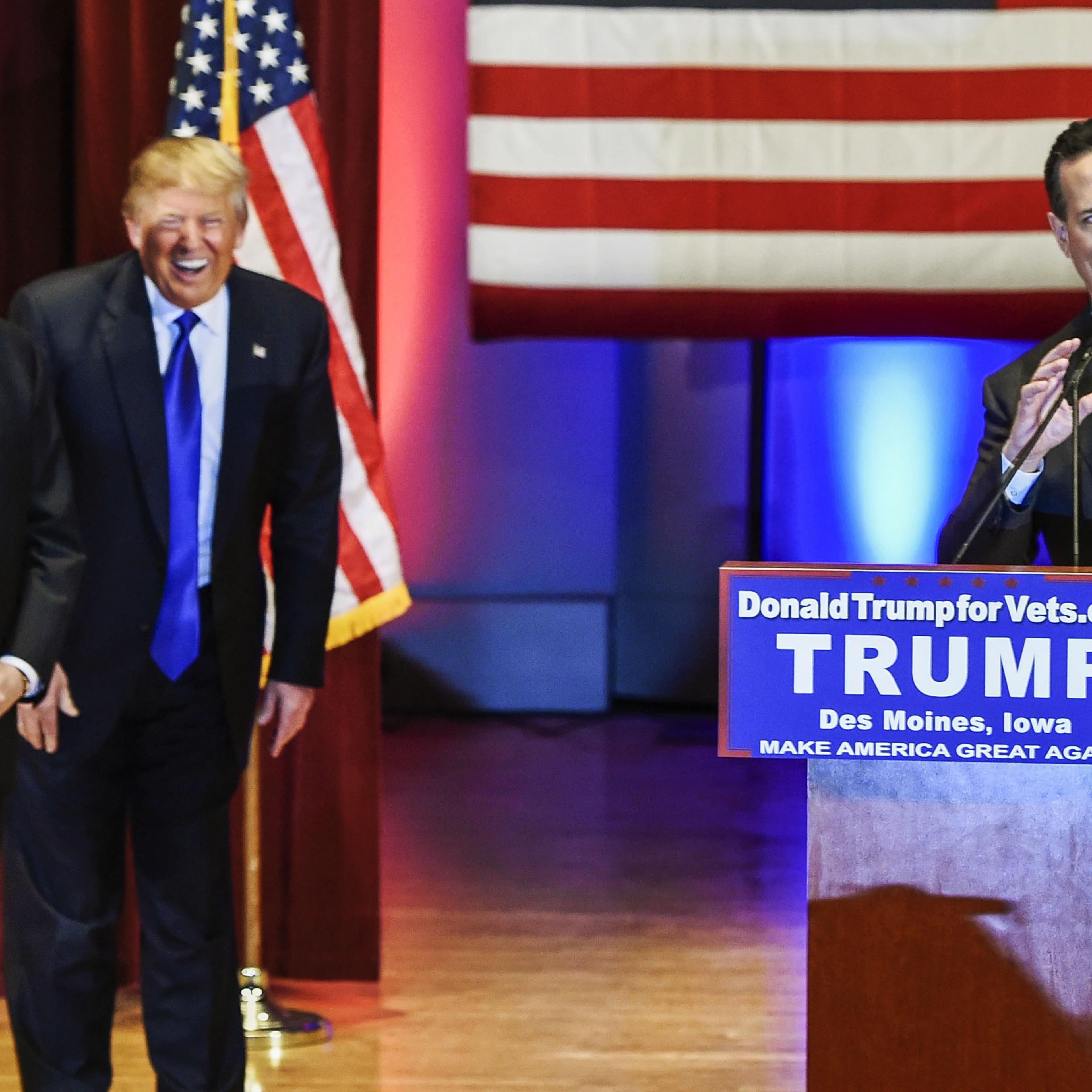 Republican presidential candidates, from left, Mike Huckabee, Donald Trump and Rick Santorum appear at a special event to benefit veterans organizations at Drake University instead of participating in a Fox News debate in Des Moines, Iowa, on Jan 28, 201