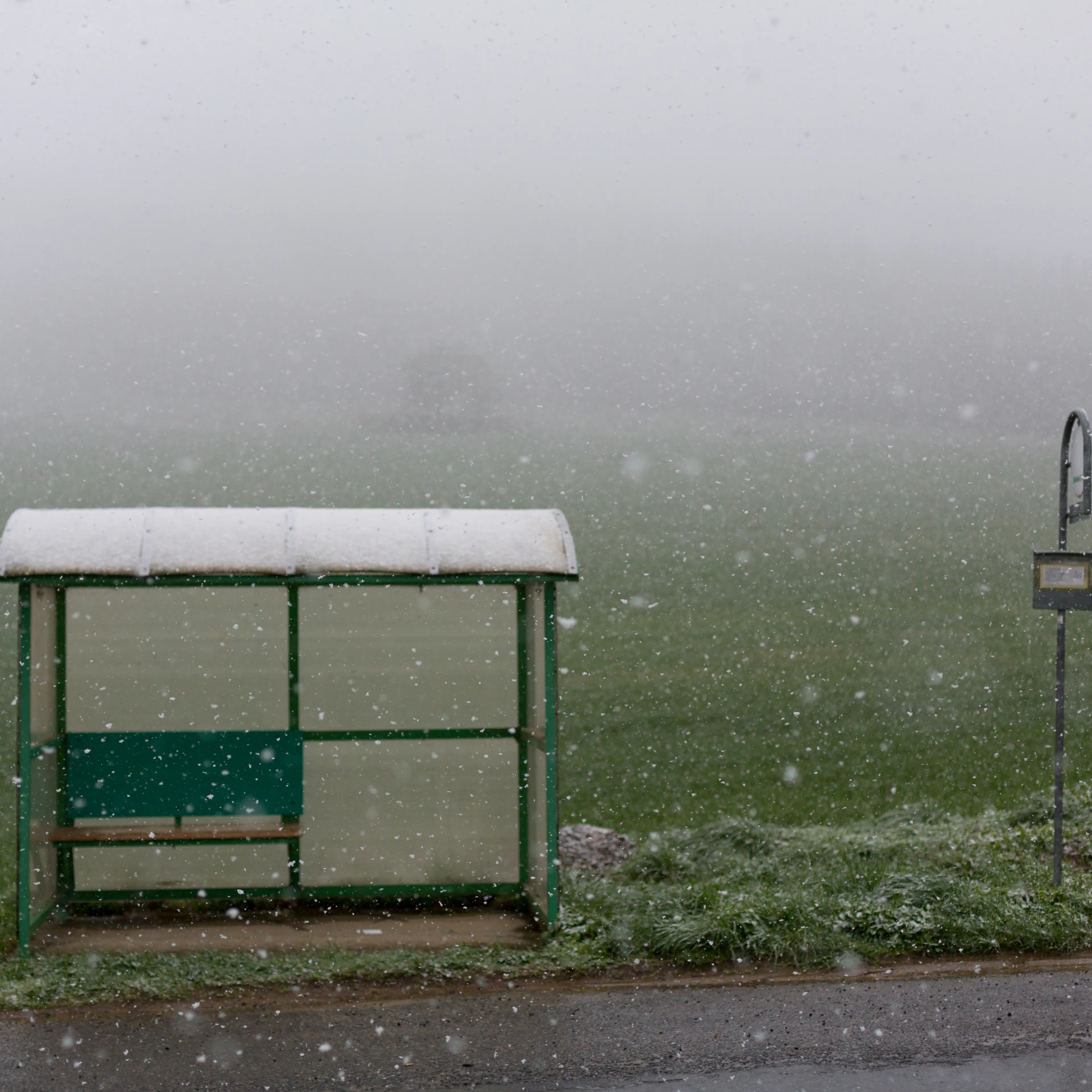 Bus stop, heavy snowfall, fog, road