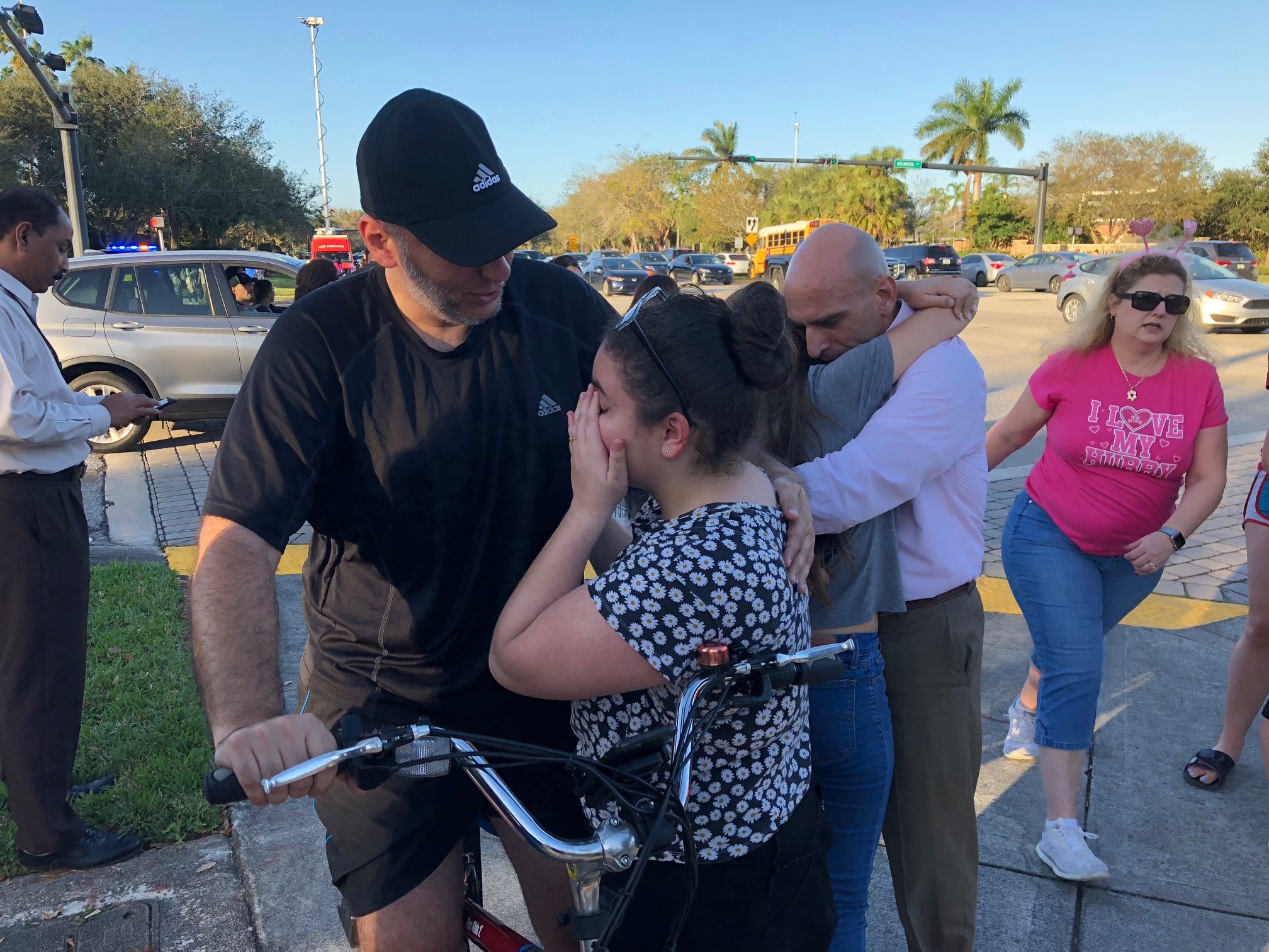 People react at Marjory Stoneman Douglas High School in Parkland, Florida, a city about 50 miles (80 kilometers) north of Miami on Feb. 14, 2018 following a school shooting.