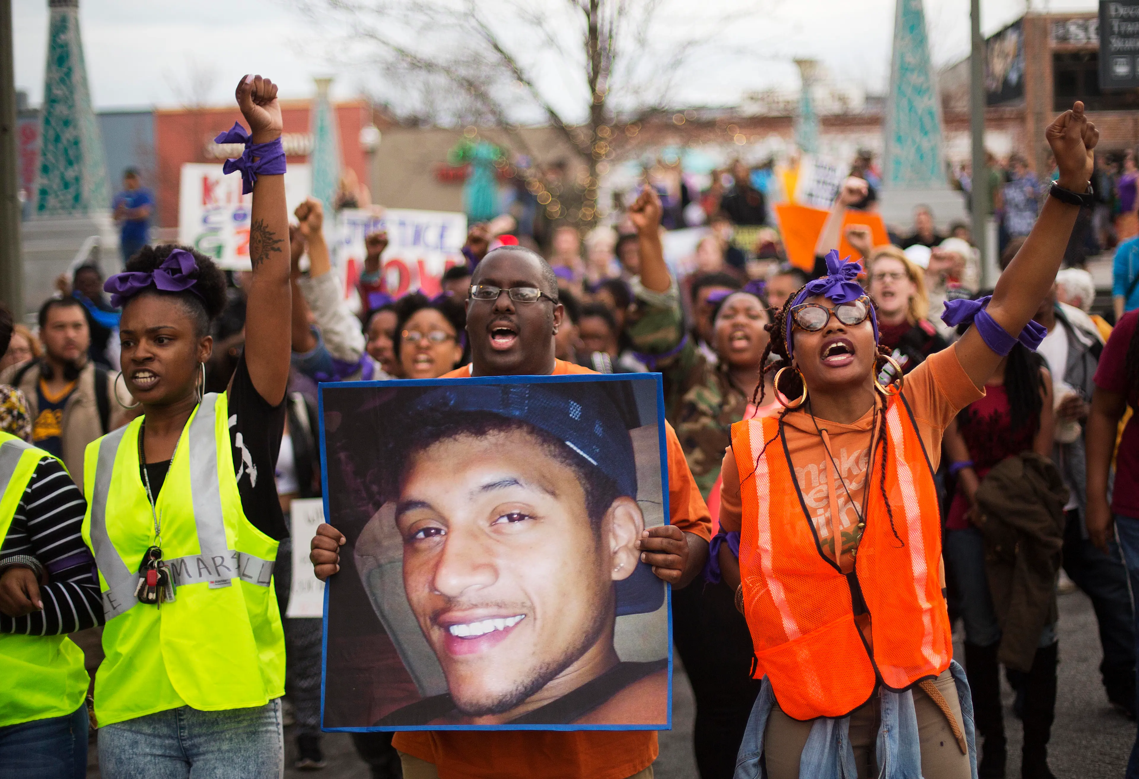 Protesters carry a photo of Anthony Hill while marching through the street demonstrating Hill's shooting death by a police officer in Decatur, Ga. on March 11, 2015.