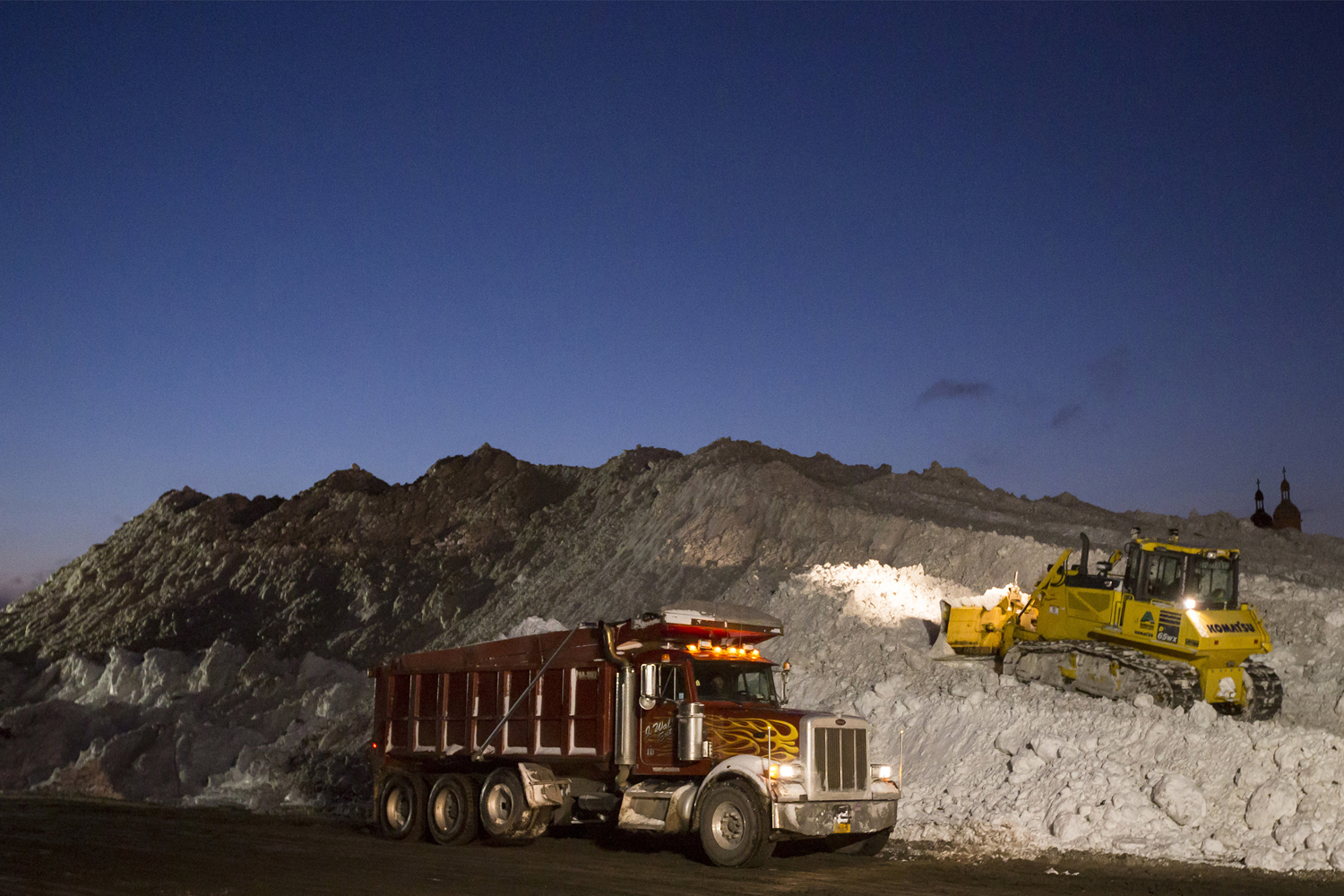 Heavy equipment transport and dump snow outside the abandoned Central Terminal rail station in Buffalo, east side New York
