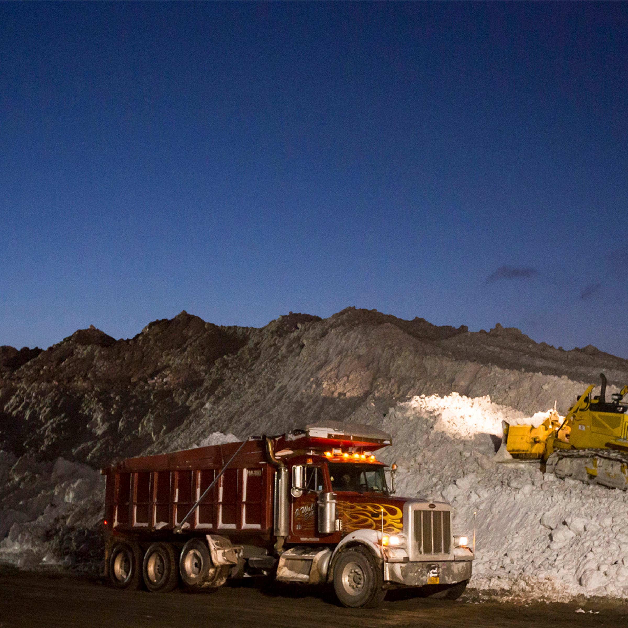 Heavy equipment transport and dump snow outside the abandoned Central Terminal rail station in Buffalo, east side New York