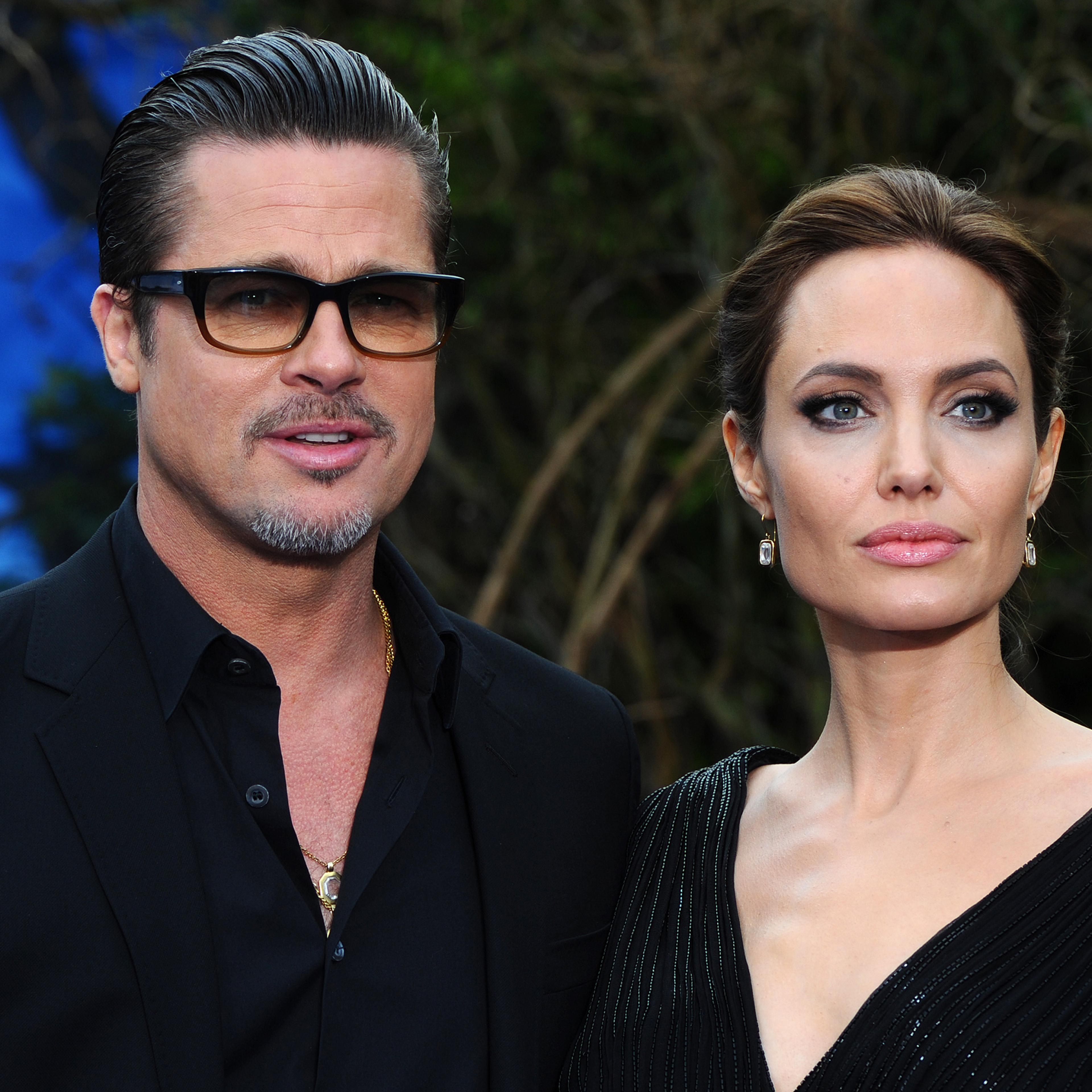 Brad Pitt and Angelina Jolie attend a private reception as costumes and props from Disney's "Maleficent" are exhibited in support of Great Ormond Street Hospital at Kensington Palace in London on May 8, 2014.