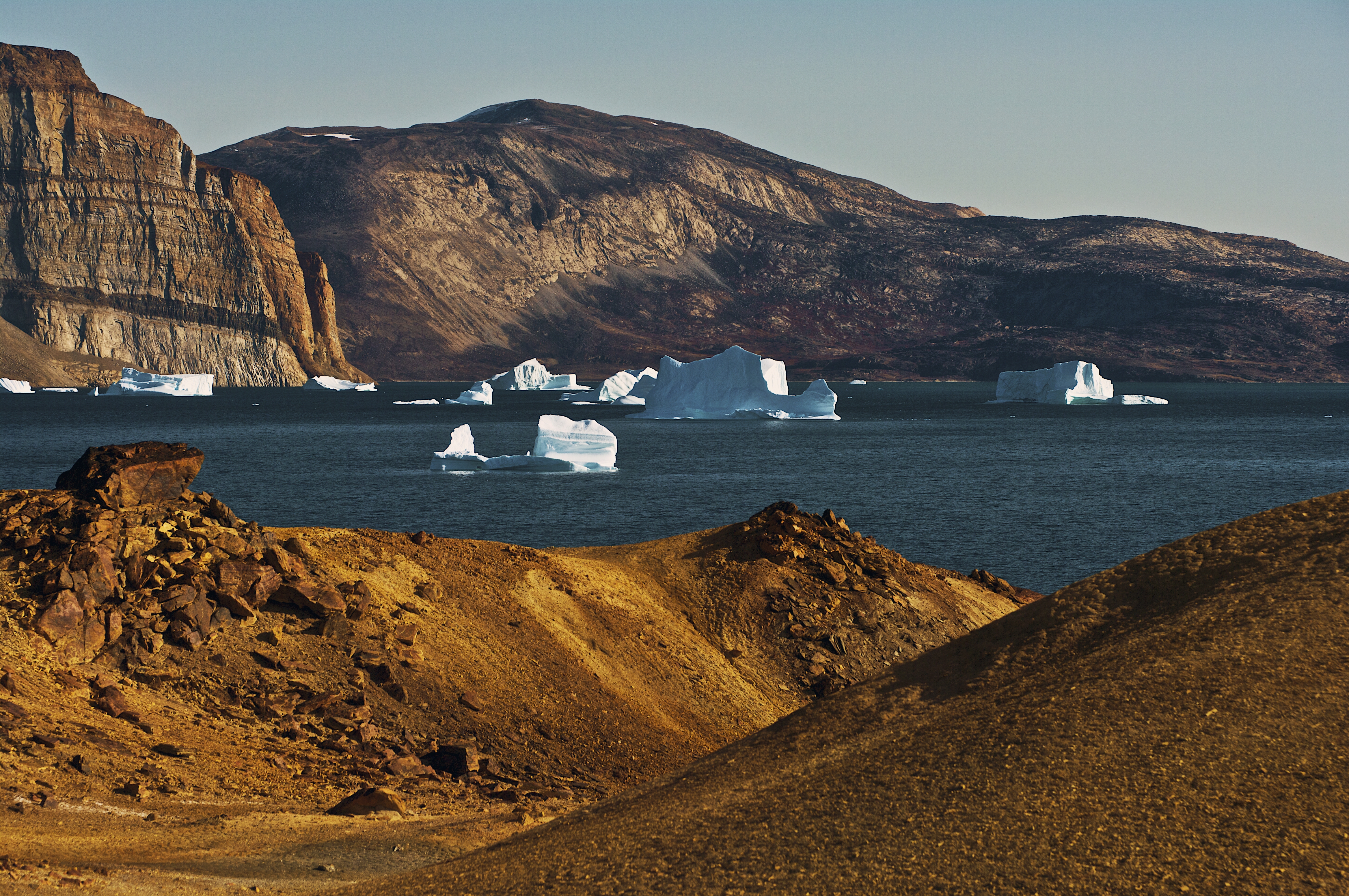 The arctic desert with icebergs in the background, Uummannaq, Qaasuitsup, west Greenland, Denmark on May 5, 2014.
