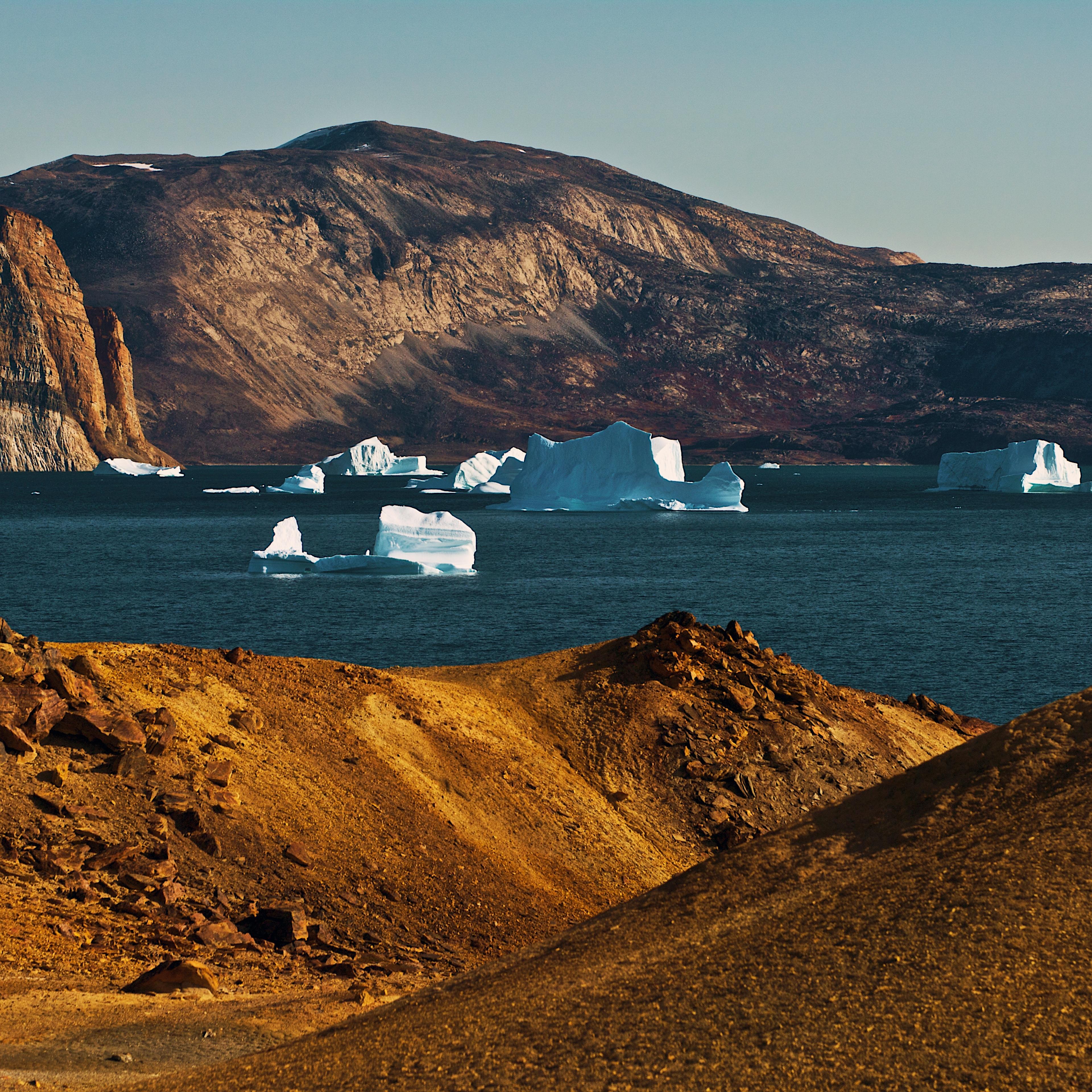 The arctic desert with icebergs in the background, Uummannaq, Qaasuitsup, west Greenland, Denmark on May 5, 2014.