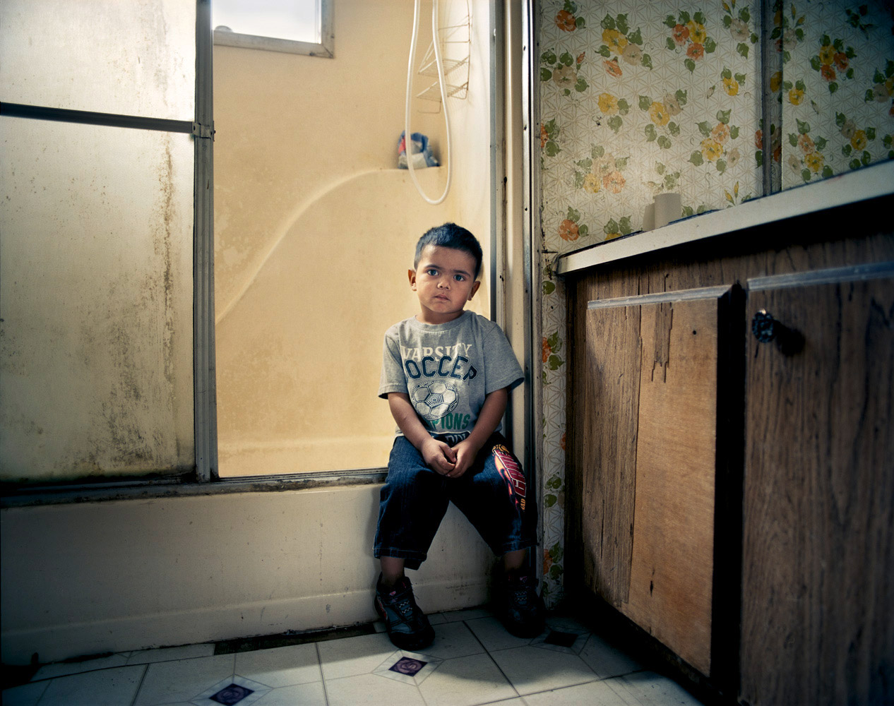 Eric, 3, lives with two siblings, their mother and grandparents in a trailer park for migrant farm workers in Firebaugh, Calif. His grandmother regularly walks two miles with him to pick up free food from the local community center to supplement the family’s $350/week income.