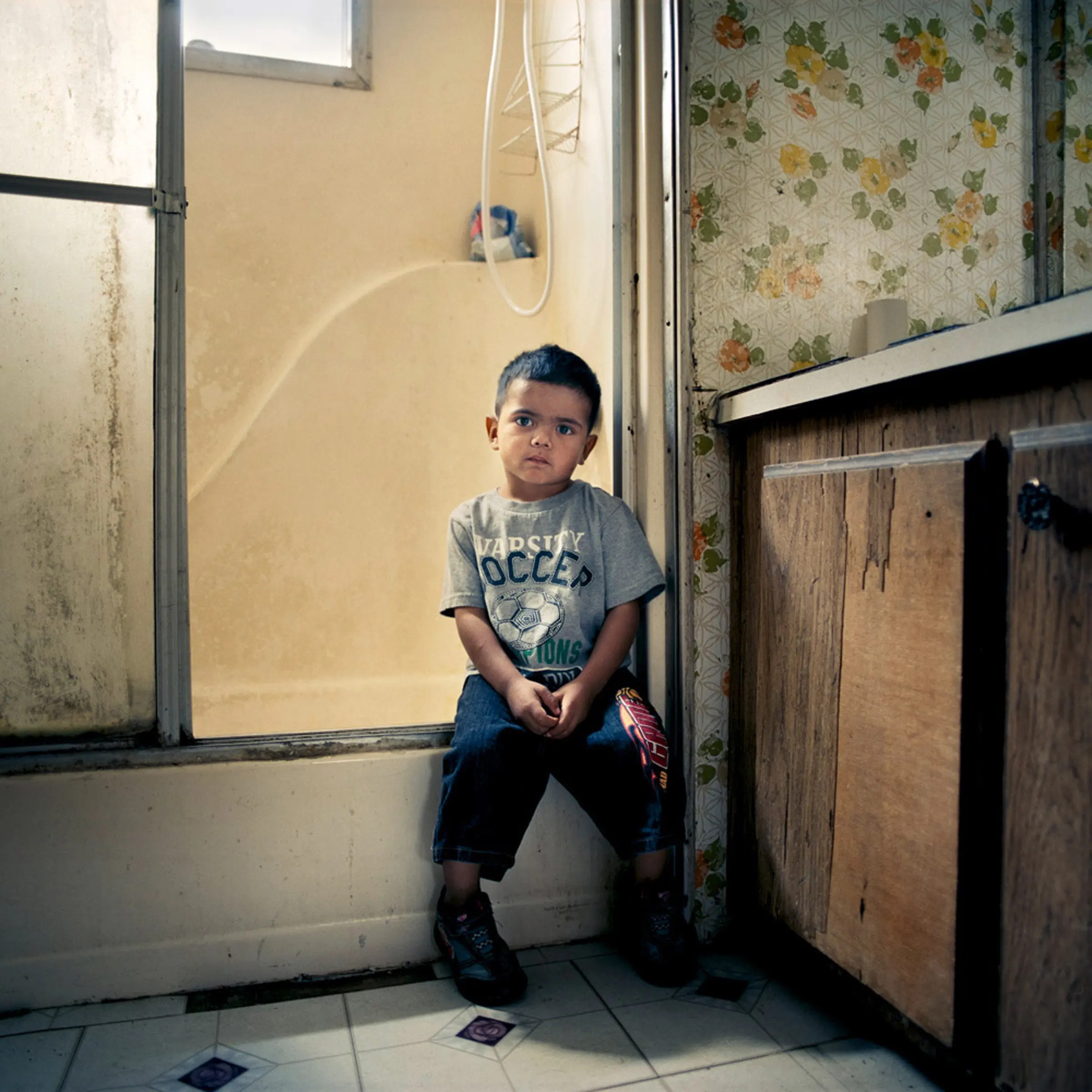 Eric, 3, lives with two siblings, their mother and grandparents in a trailer park for migrant farm workers in Firebaugh, Calif. His grandmother regularly walks two miles with him to pick up free food from the local community center to supplement the family’s $350/week income.