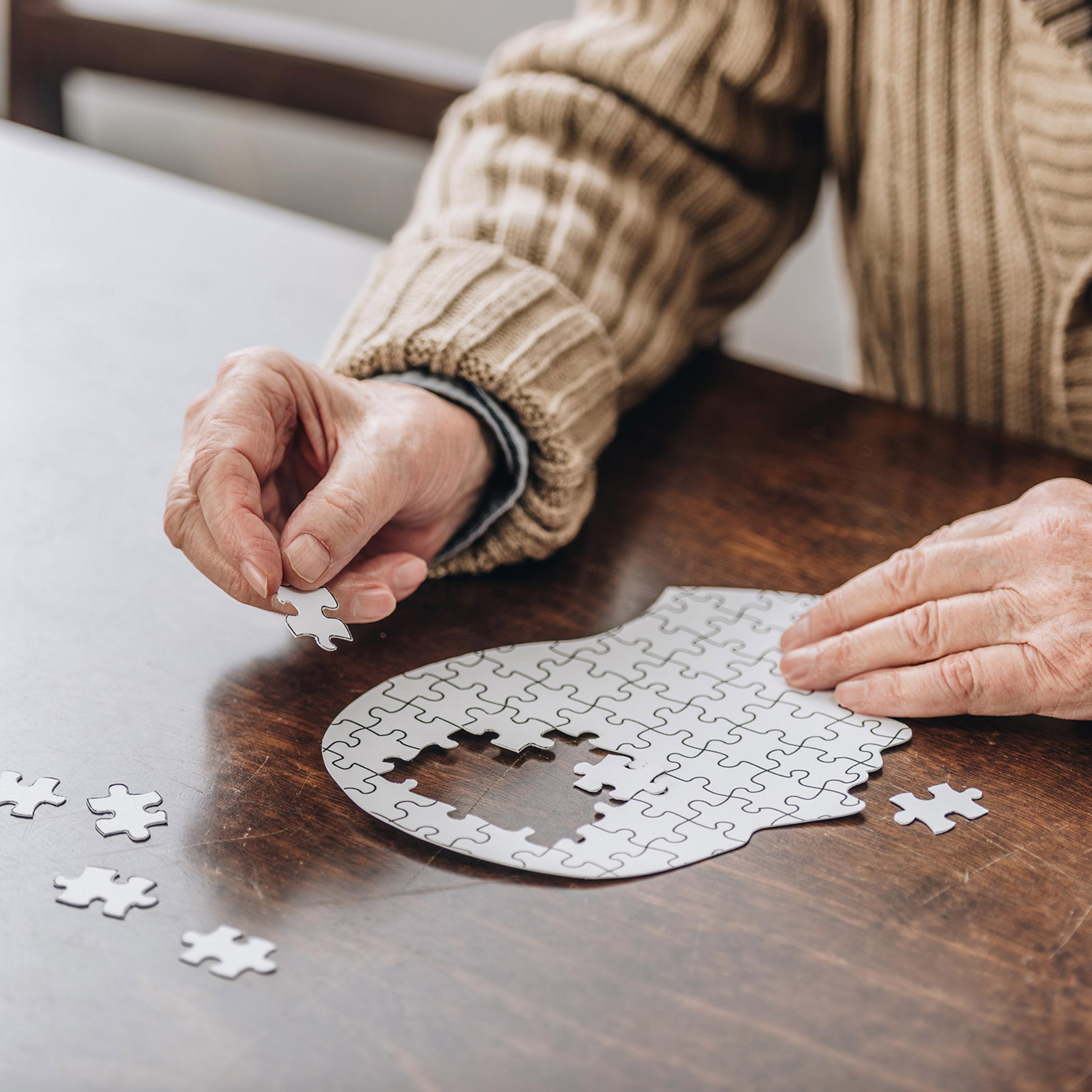 A senior playing with puzzles.