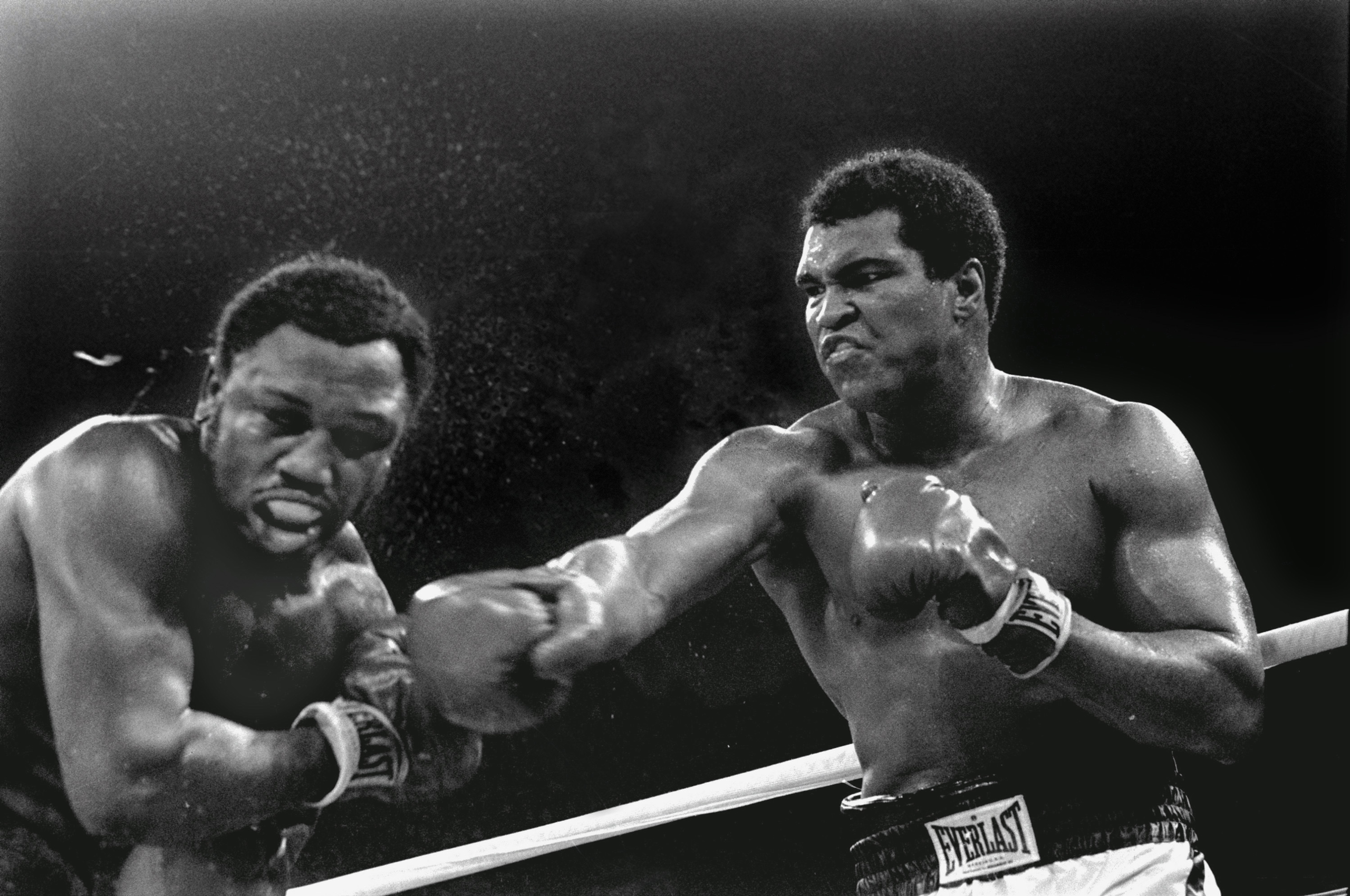 Spray flies from the head of challenger Joe Frazier as heavyweight champion Muhammad Ali connects with a right in the ninth round of their title fight in Manila, Philippines, October 1, 1975. Ali won the fight on a decision to retain the title. (AP Photo