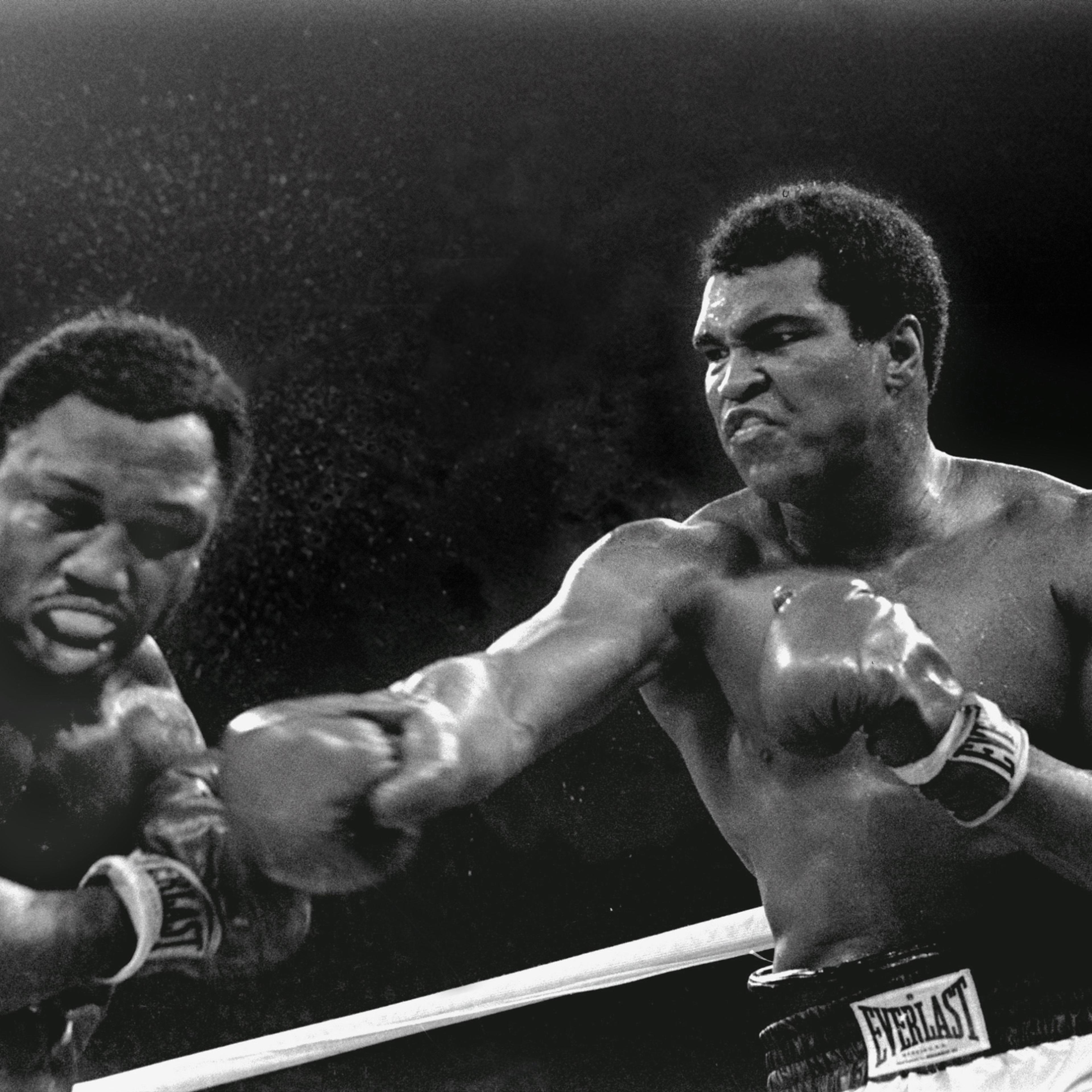 Spray flies from the head of challenger Joe Frazier as heavyweight champion Muhammad Ali connects with a right in the ninth round of their title fight in Manila, Philippines, October 1, 1975. Ali won the fight on a decision to retain the title. (AP Photo