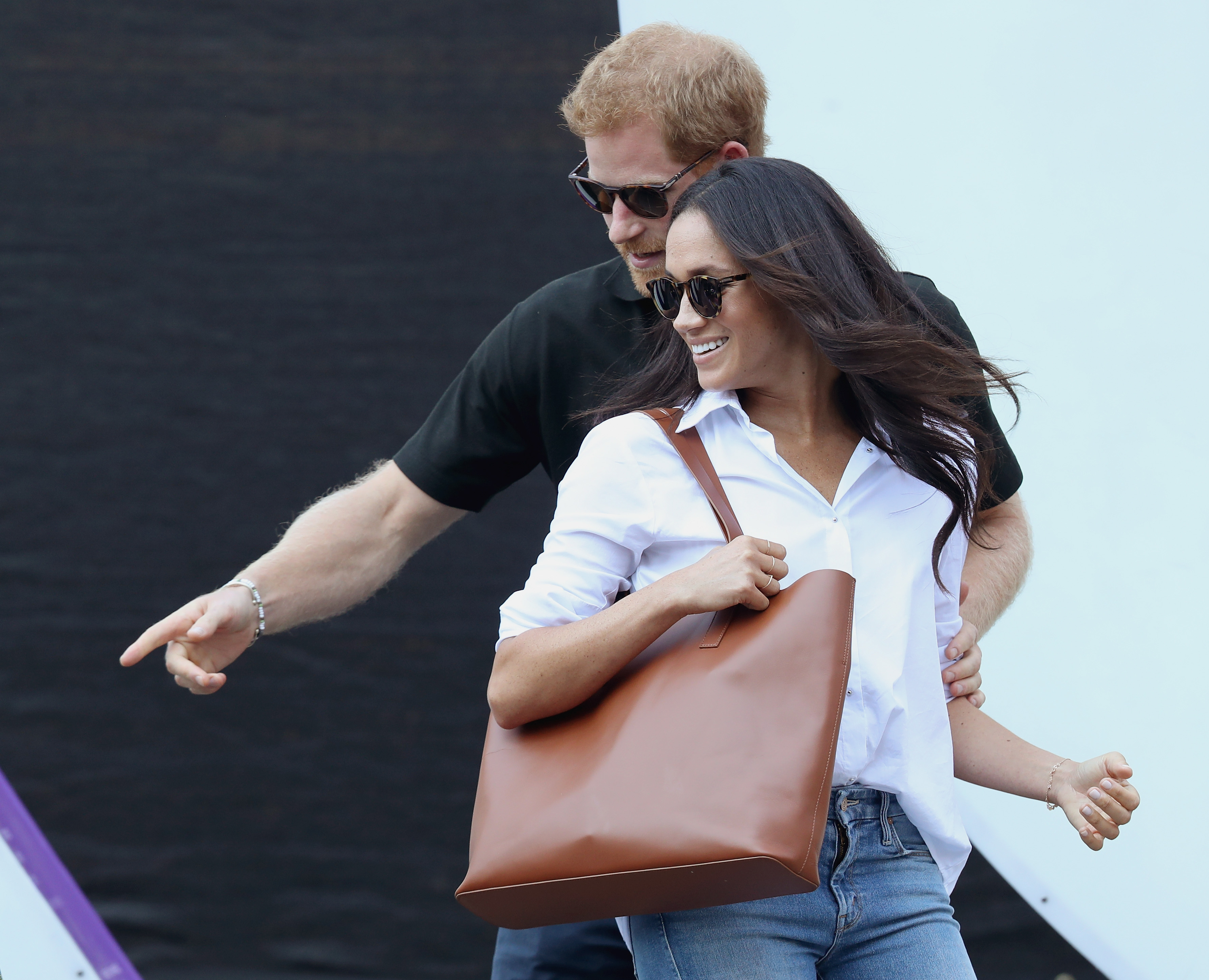 Prince Harry (L) and Meghan Markle (R) attend a Wheelchair Tennis match during the Invictus Games 2017 at Nathan Philips Square on September 25, 2017 in Toronto, Canada
