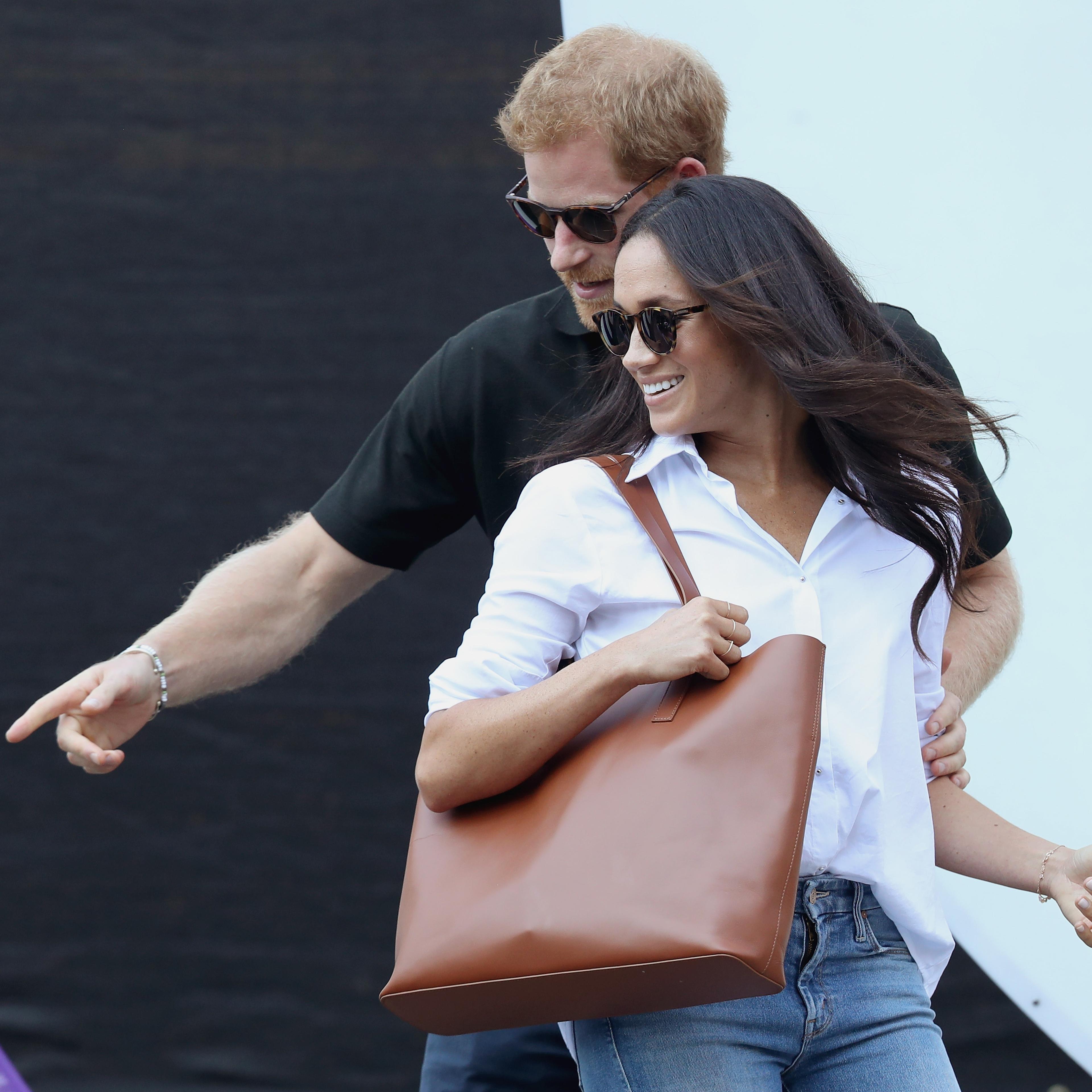 Prince Harry (L) and Meghan Markle (R) attend a Wheelchair Tennis match during the Invictus Games 2017 at Nathan Philips Square on September 25, 2017 in Toronto, Canada